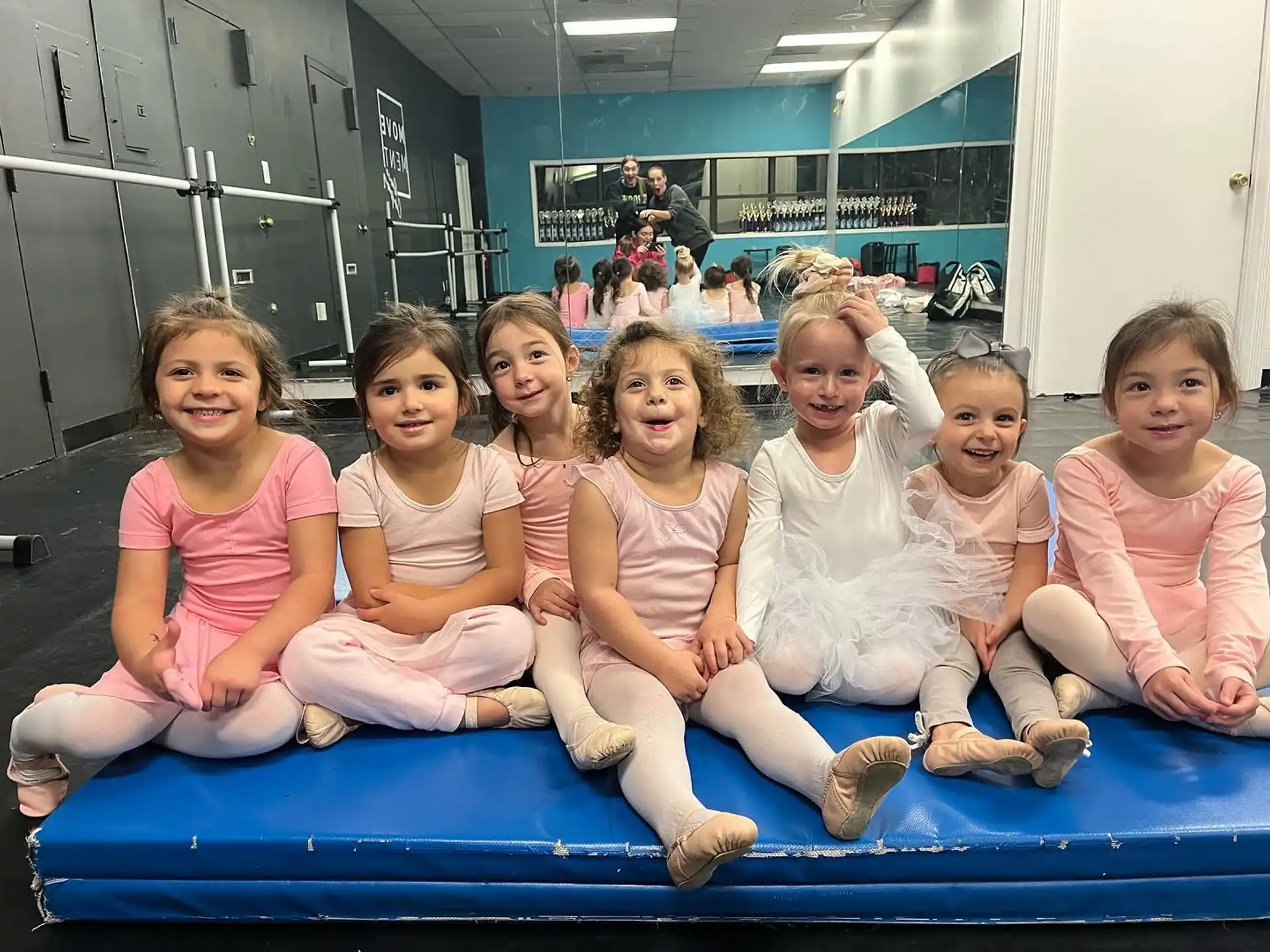a group of children sitting on a trampoline