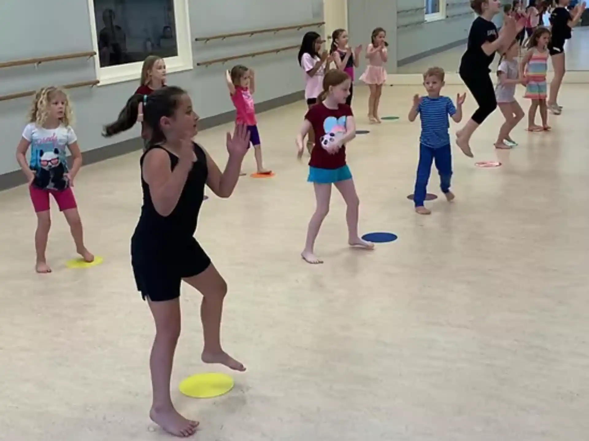 a group of children playing with frisbees