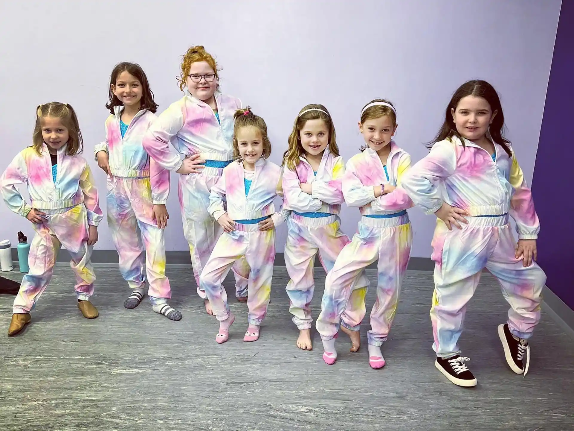 a group of girls in matching outfits