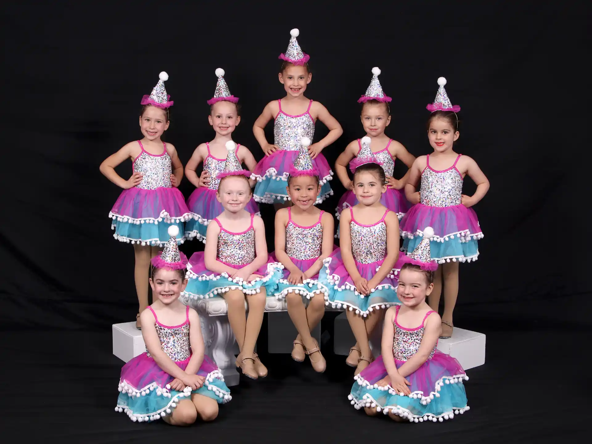 a group of girls wearing party hats