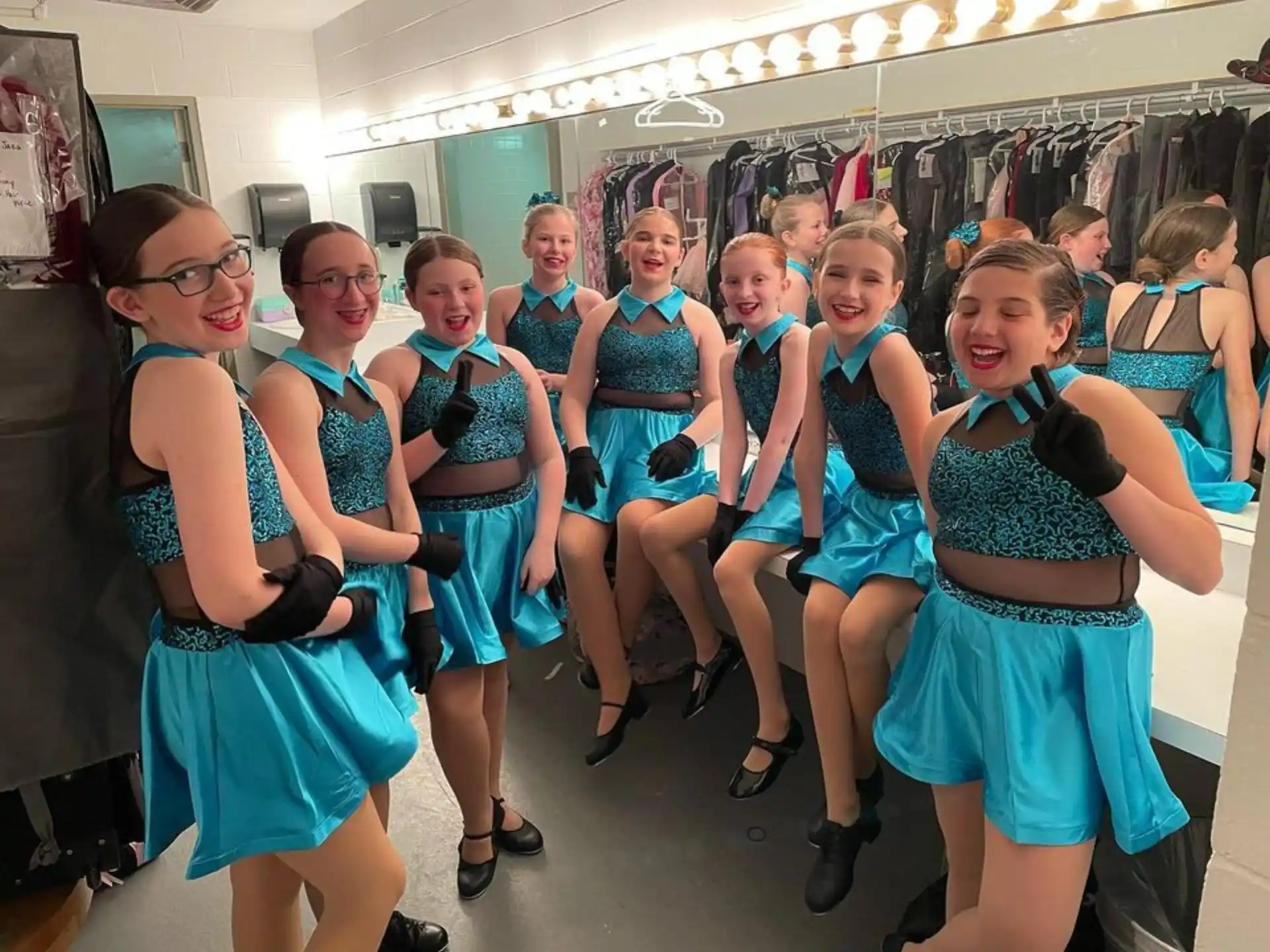 a group of girls in blue dresses