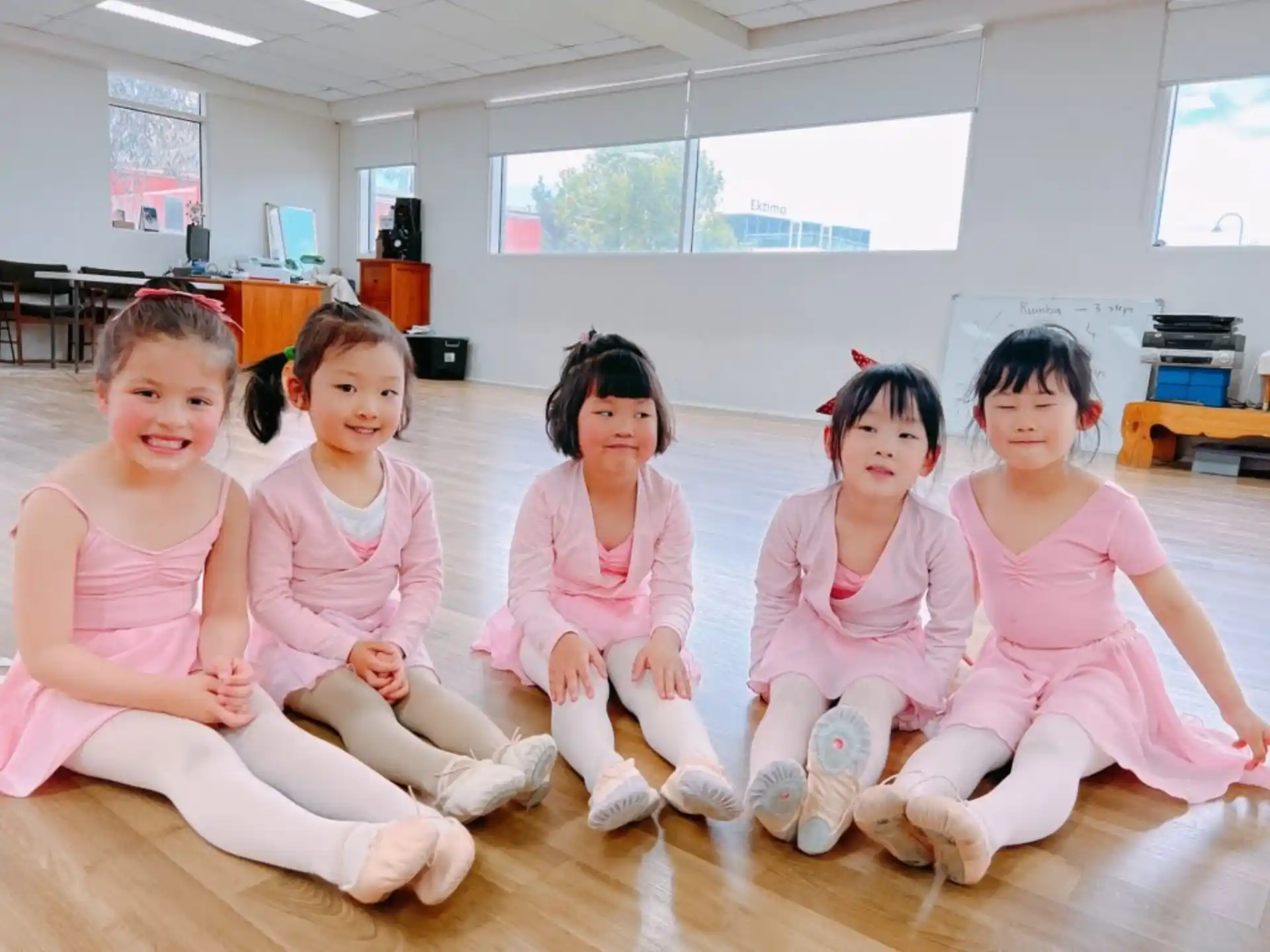 a group of girls sitting on the floor