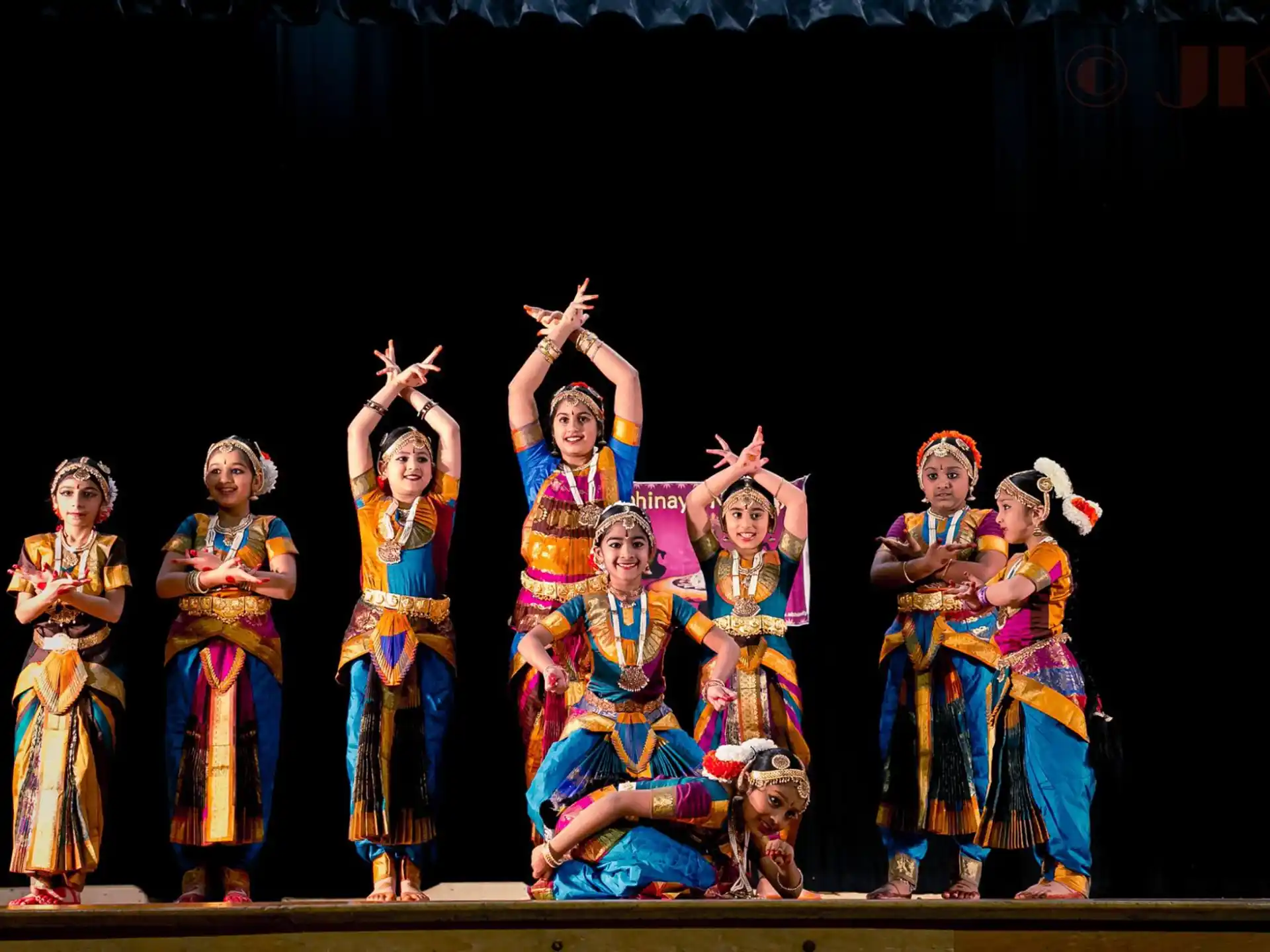 a group of women in colorful dresses