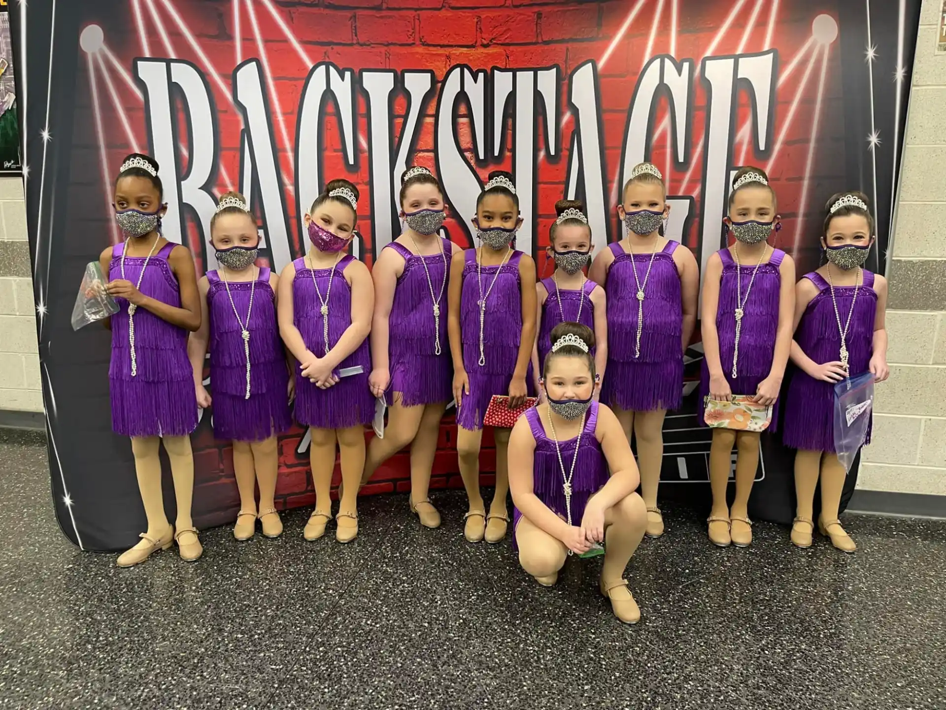a group of women in purple dresses