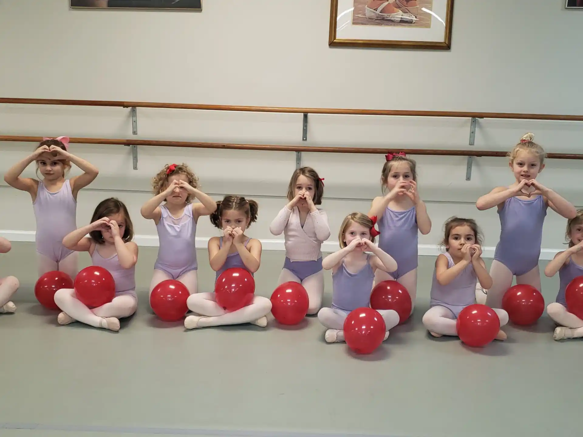 a group of women posing for a picture with balls