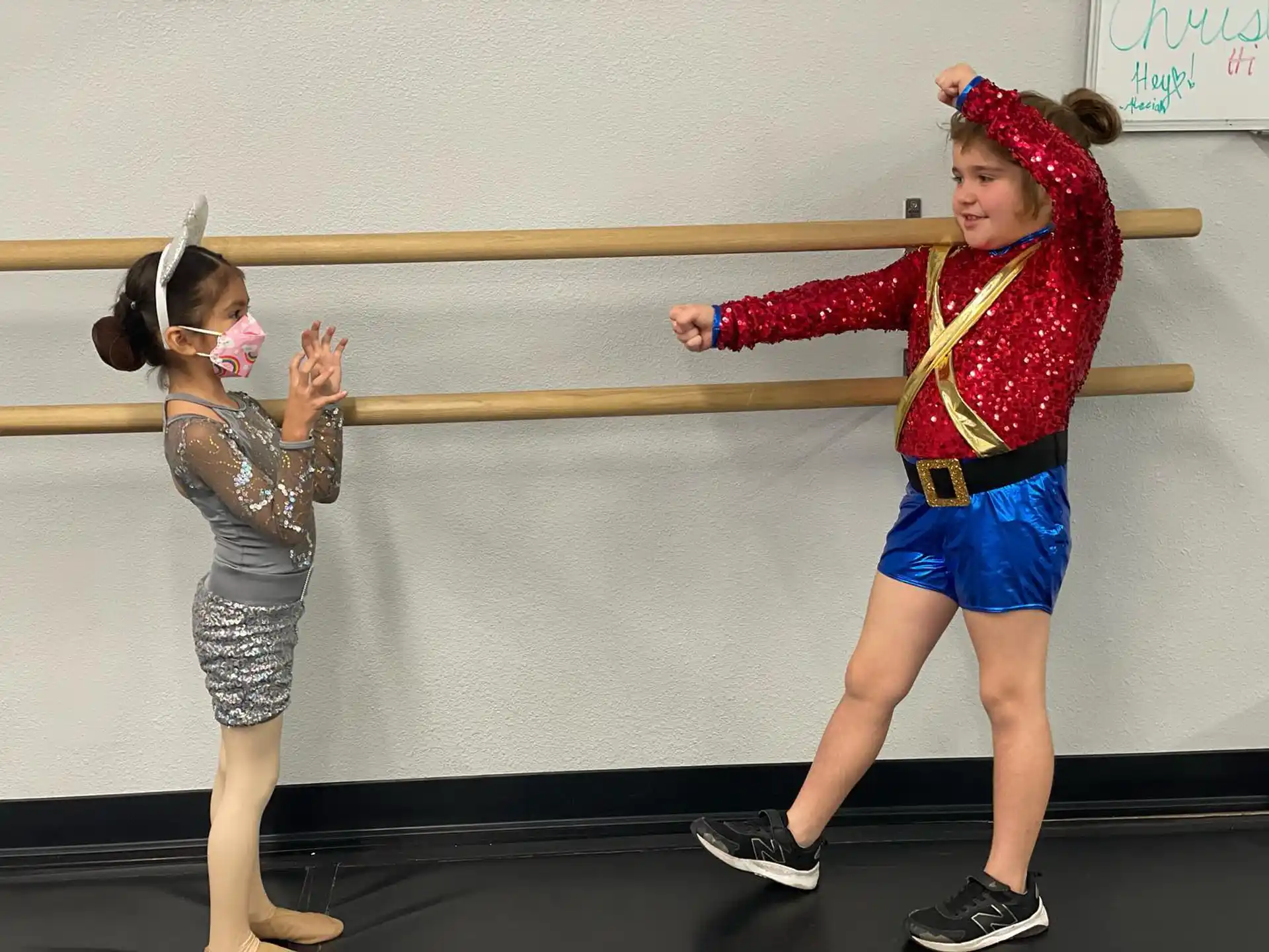 a woman and a girl holding a wooden pole