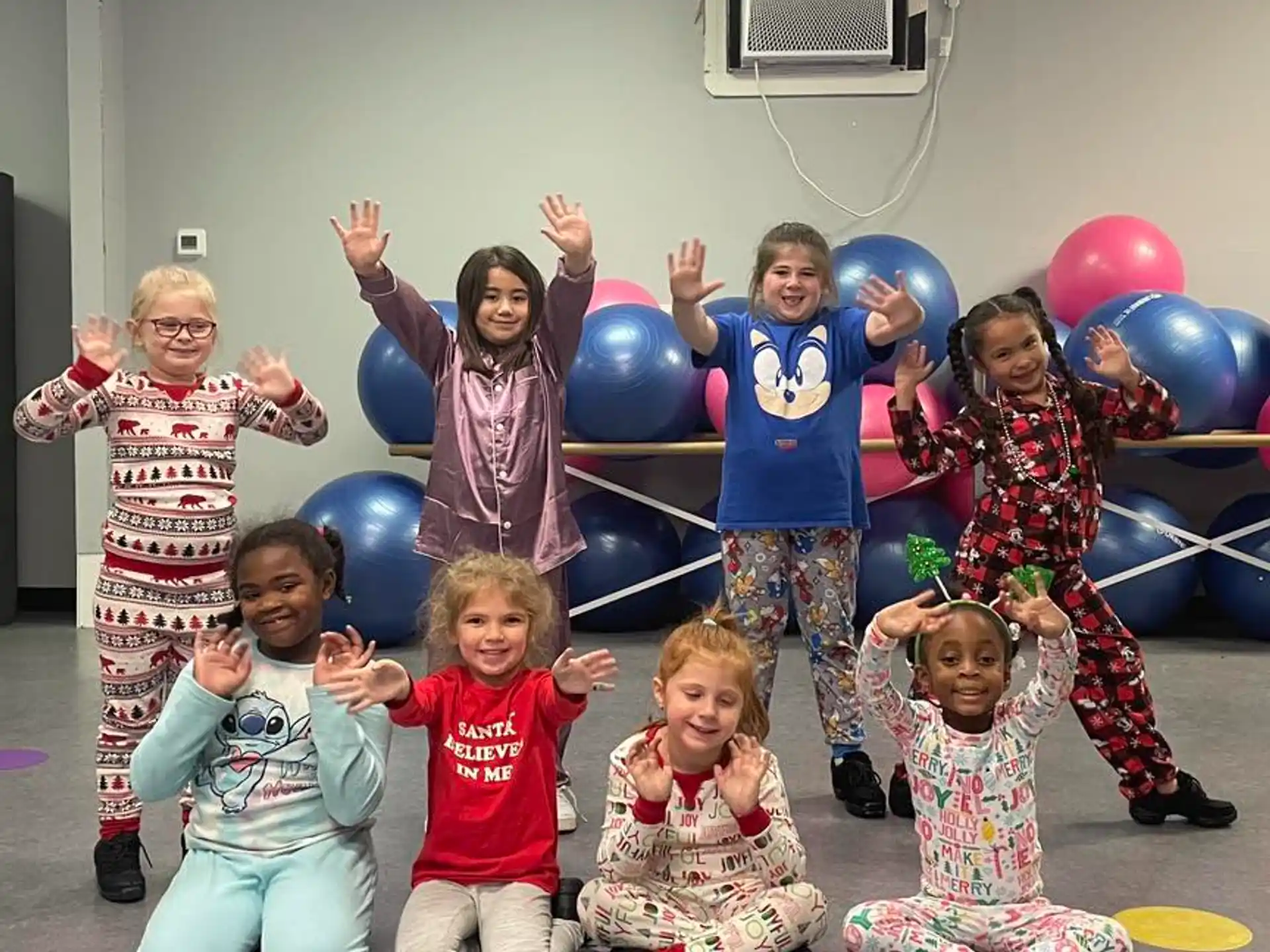 a group of children holding balloons