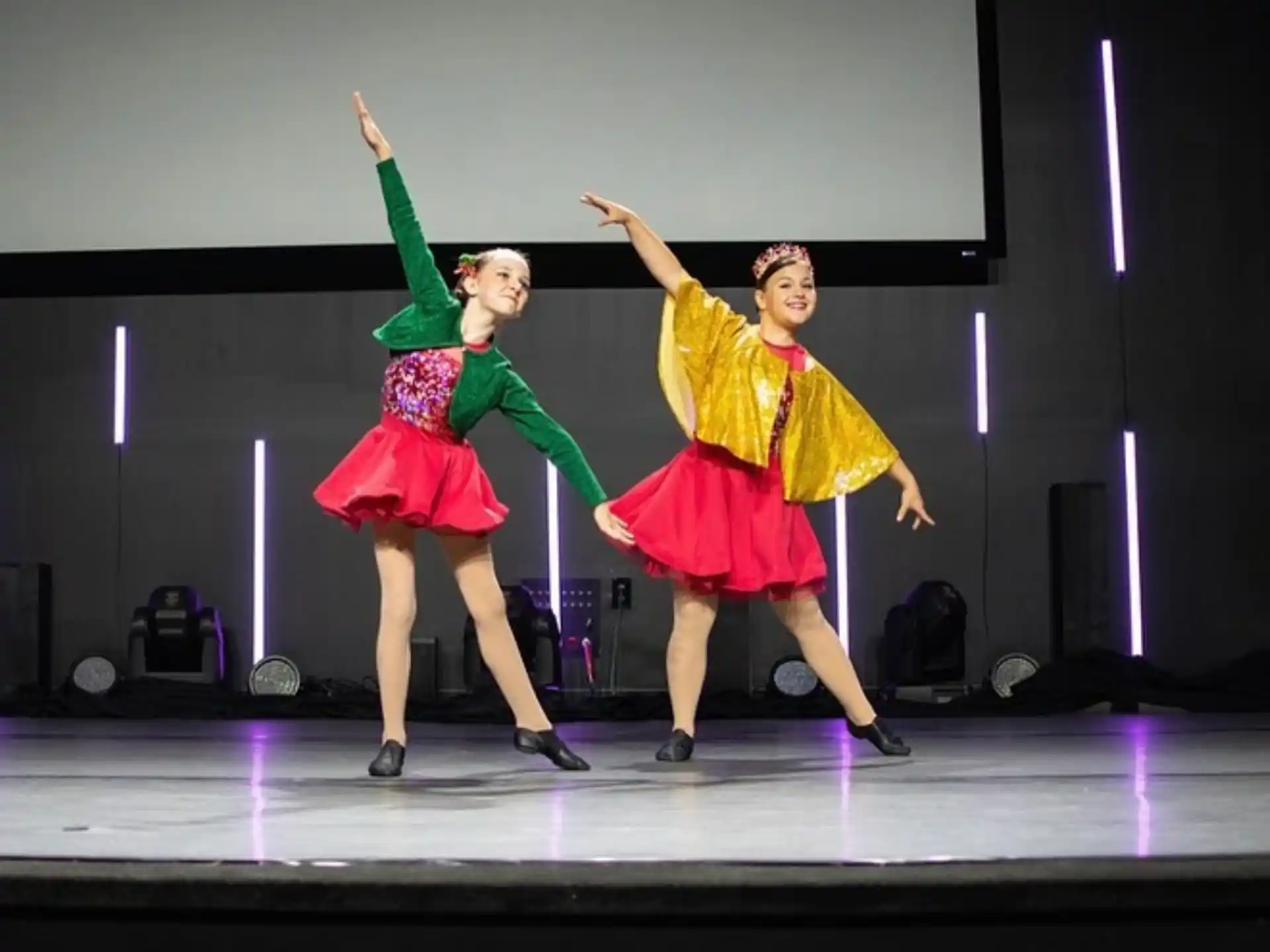 a couple of girls dancing on a stage