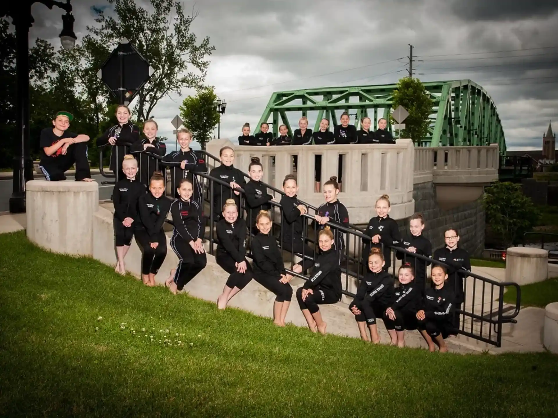 a group of people posing for a photo in front of a building