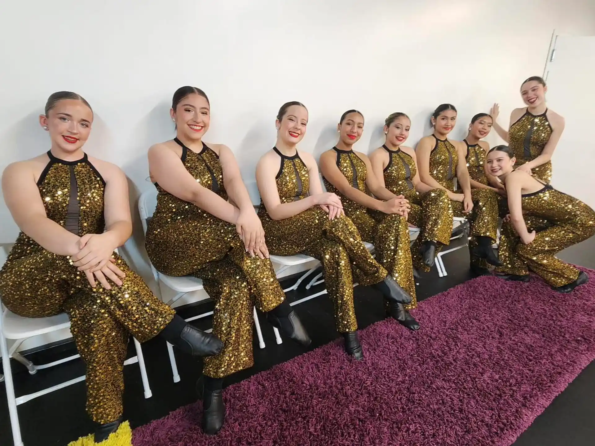 a group of people sitting on a couch posing for the camera