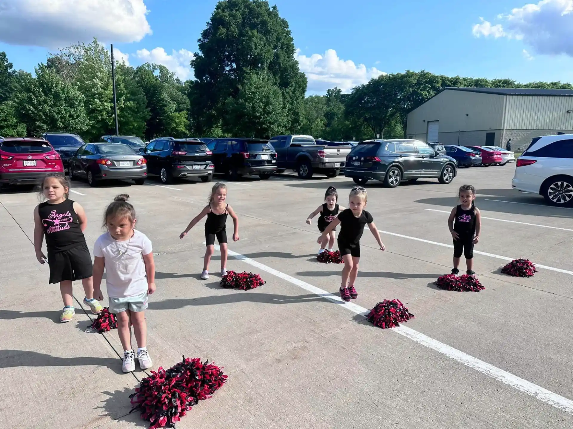 a group of girls running in a parking lot