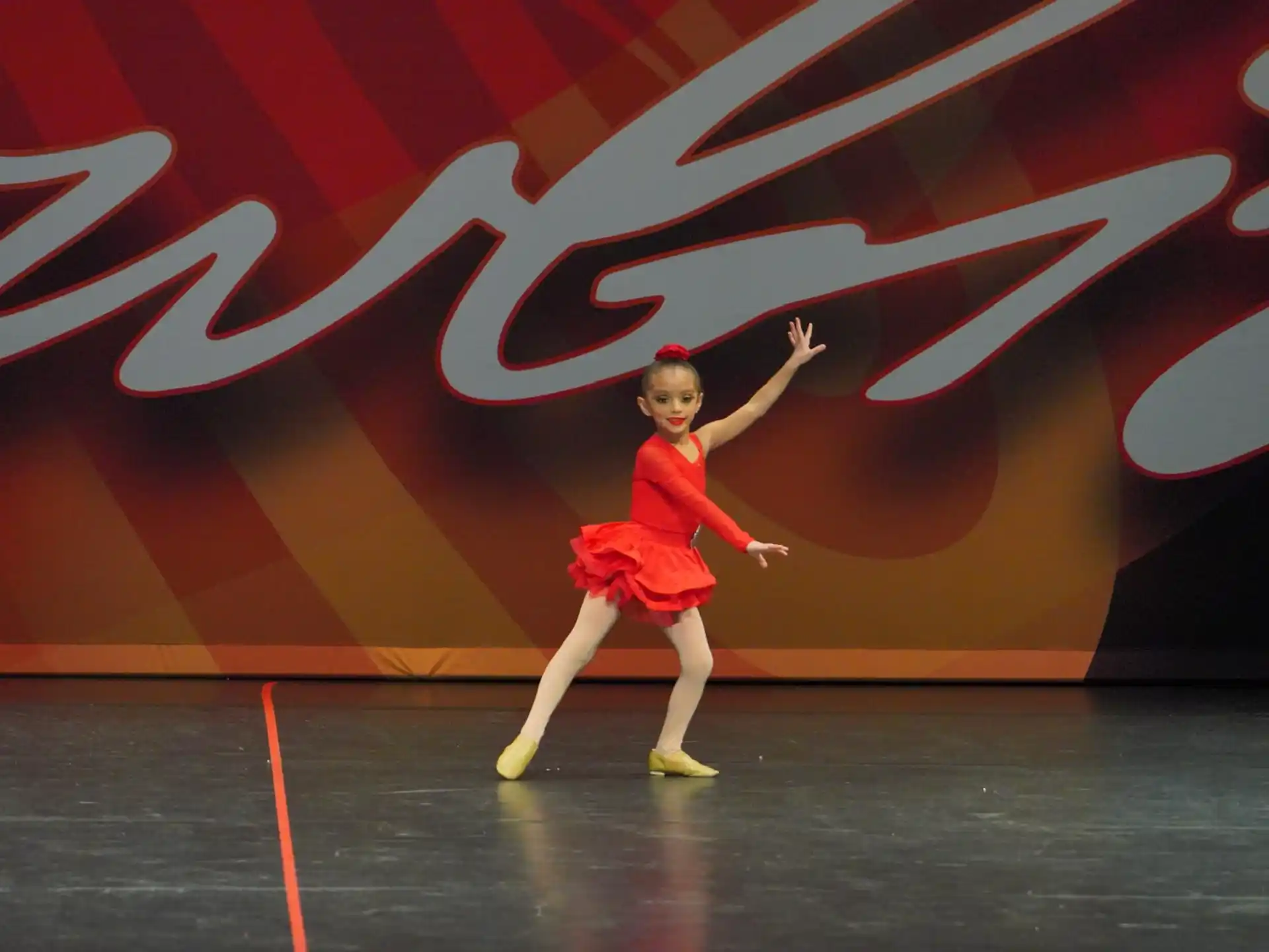 a woman in a red dress dancing