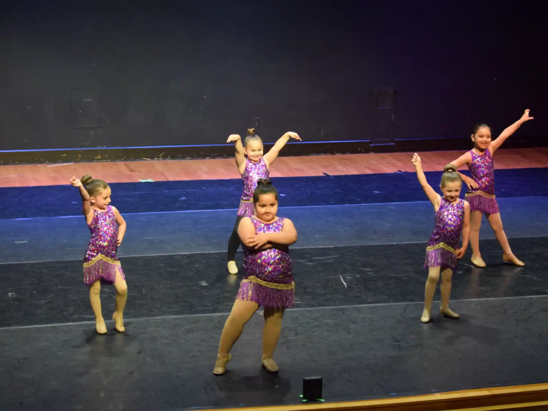 a group of girls dancing on a stage