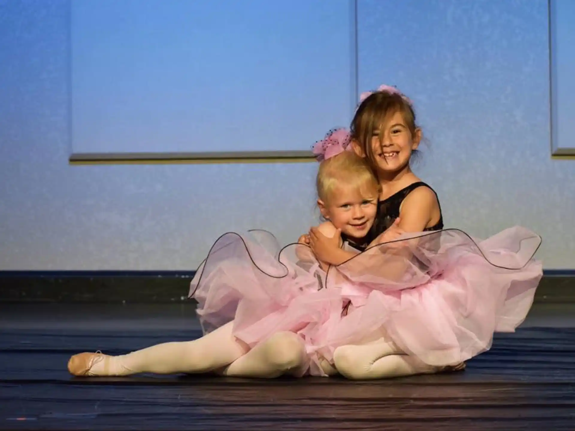 a woman and a child in a tutu