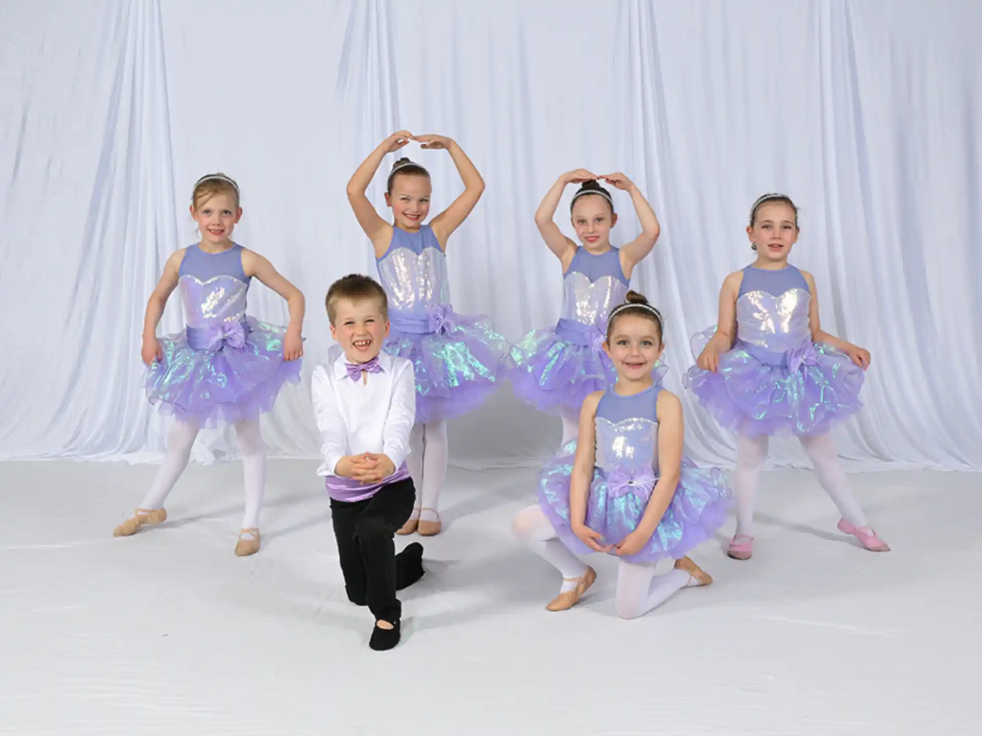 a group of children in dresses