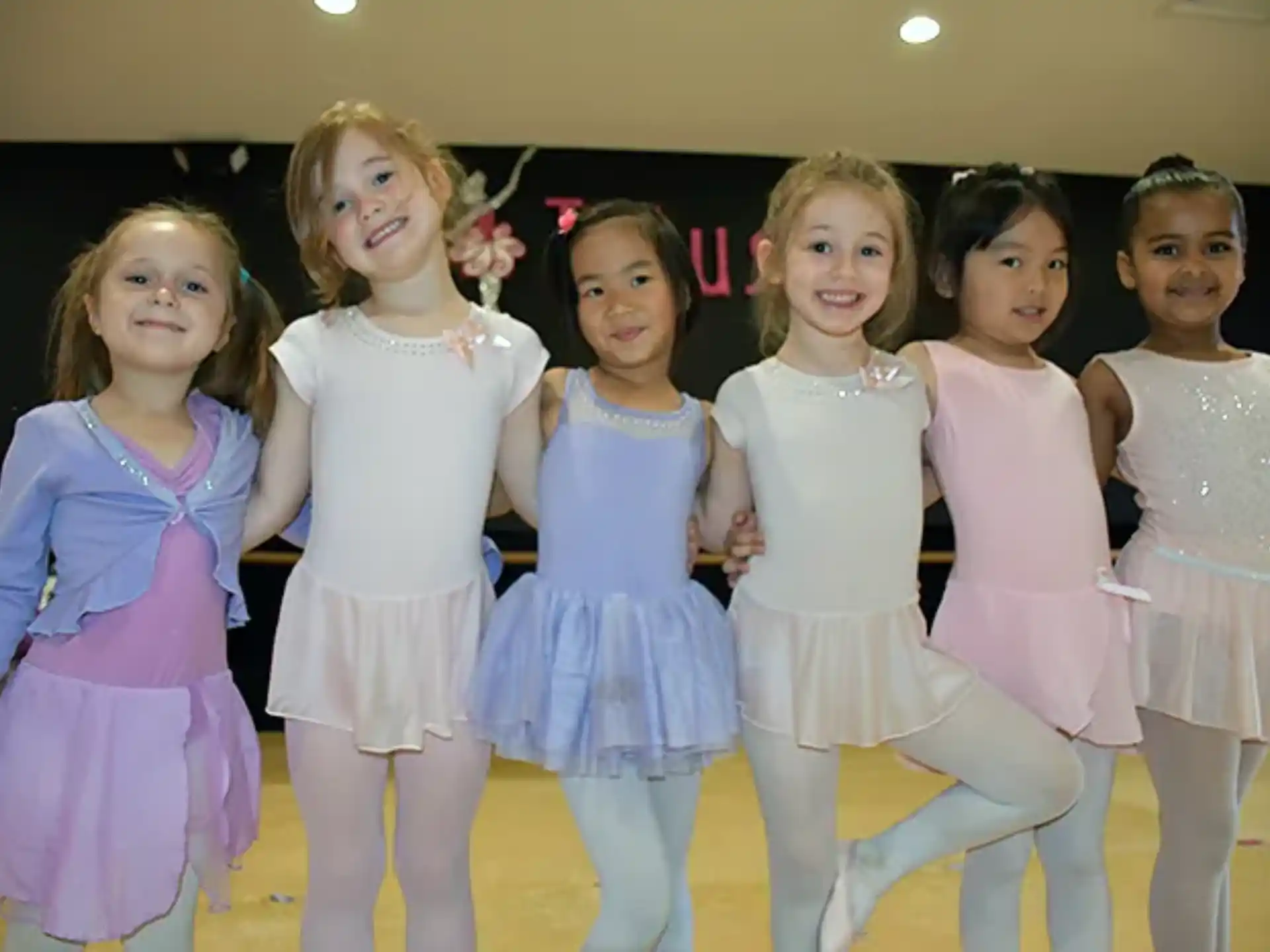 a group of girls in dresses