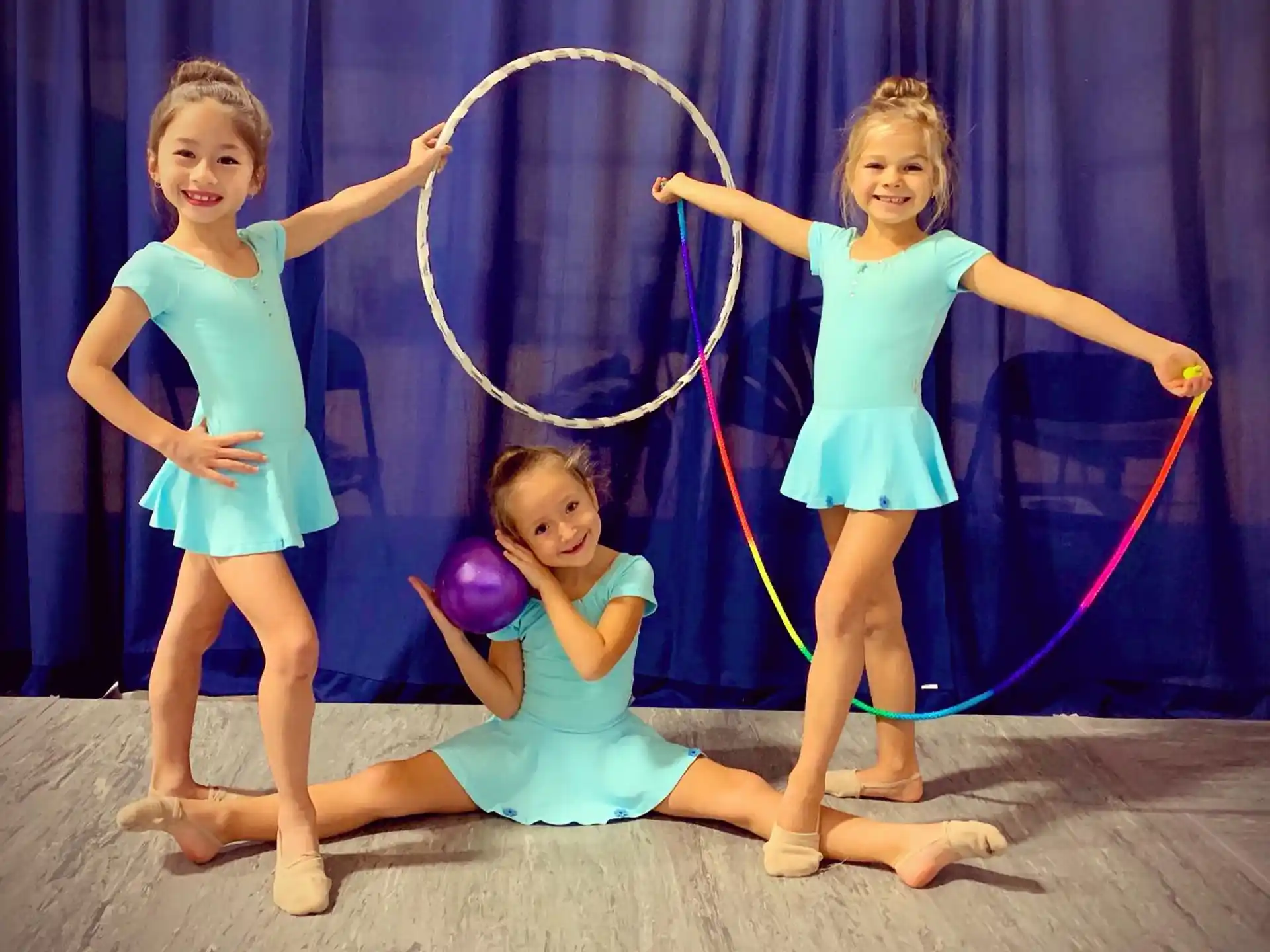 a group of girls holding a hoop