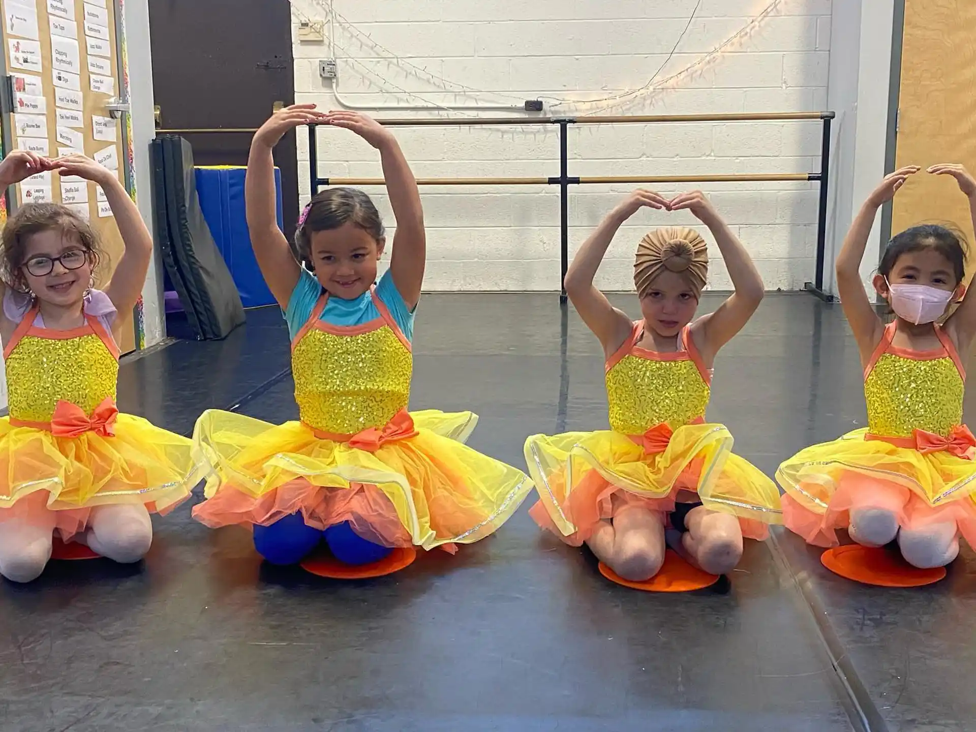 a group of children in colorful dresses