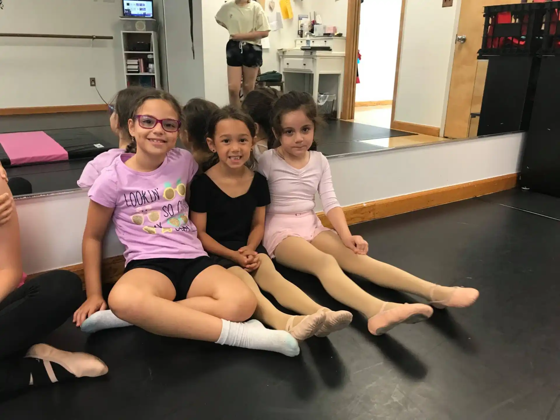 a group of girls sitting on the floor