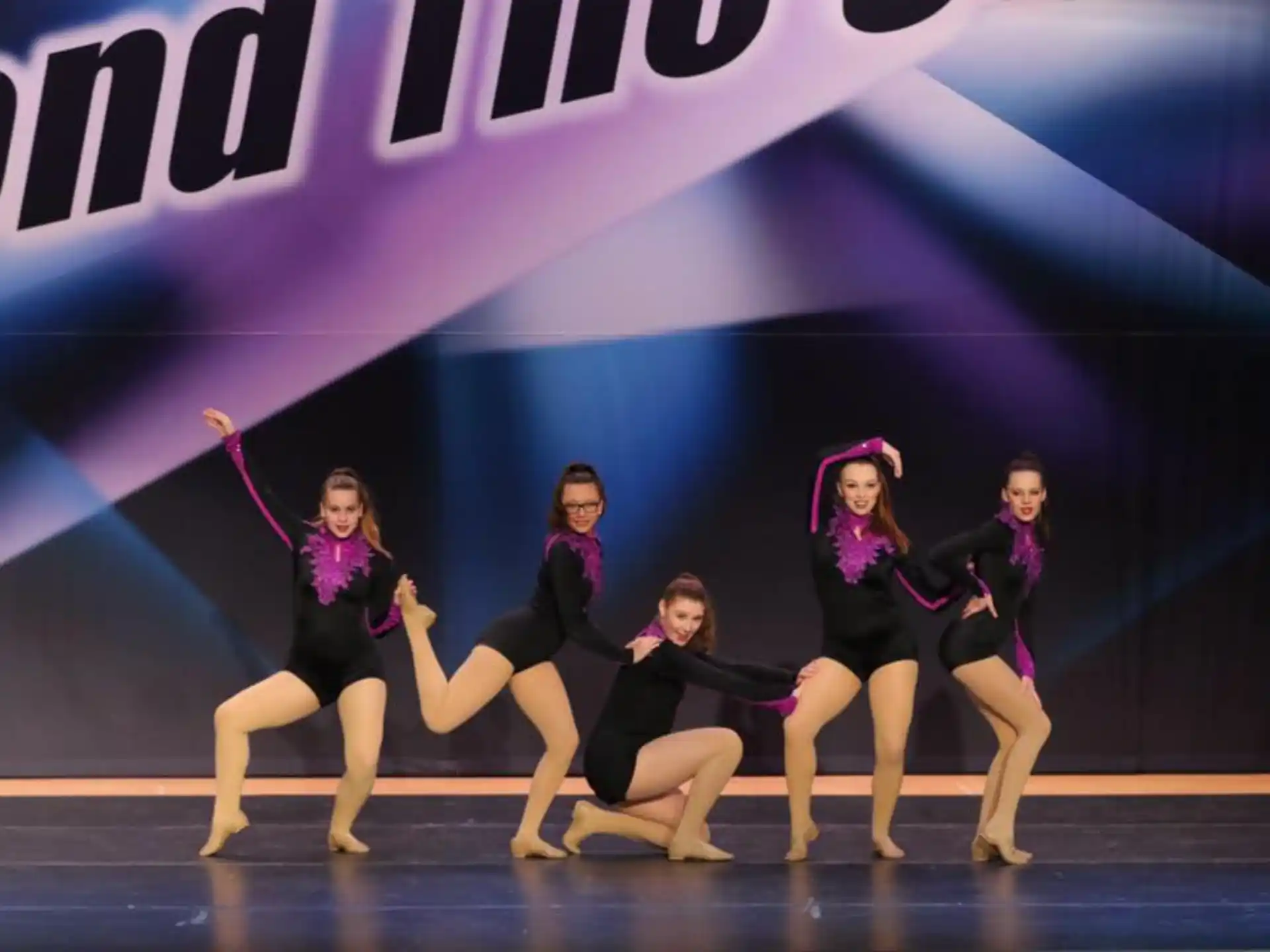 a group of women dancing on a stage