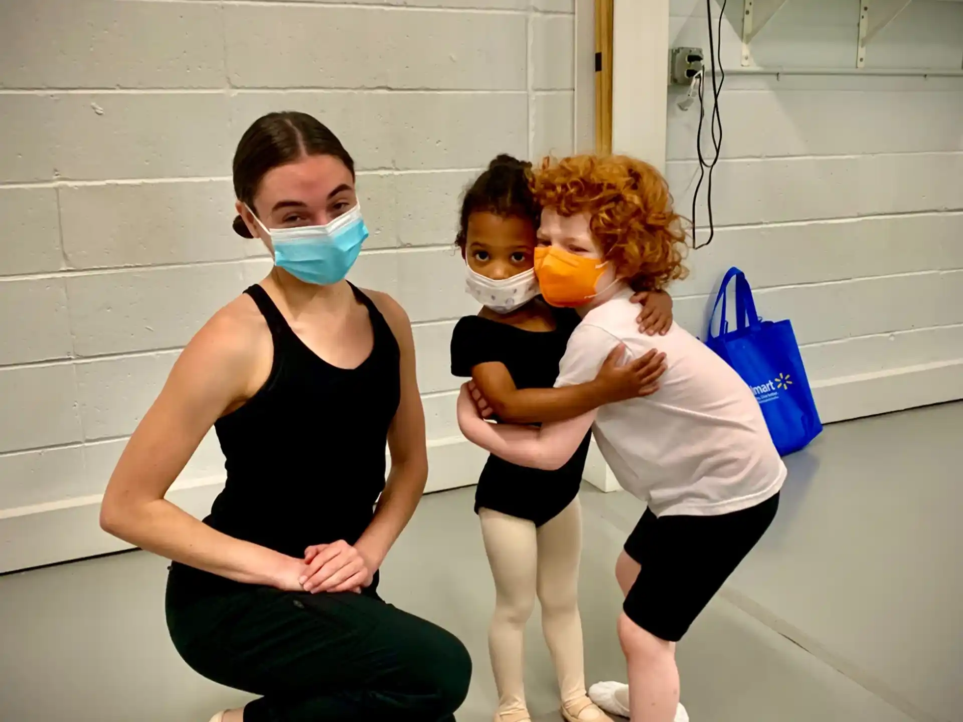 a woman and two children wearing masks