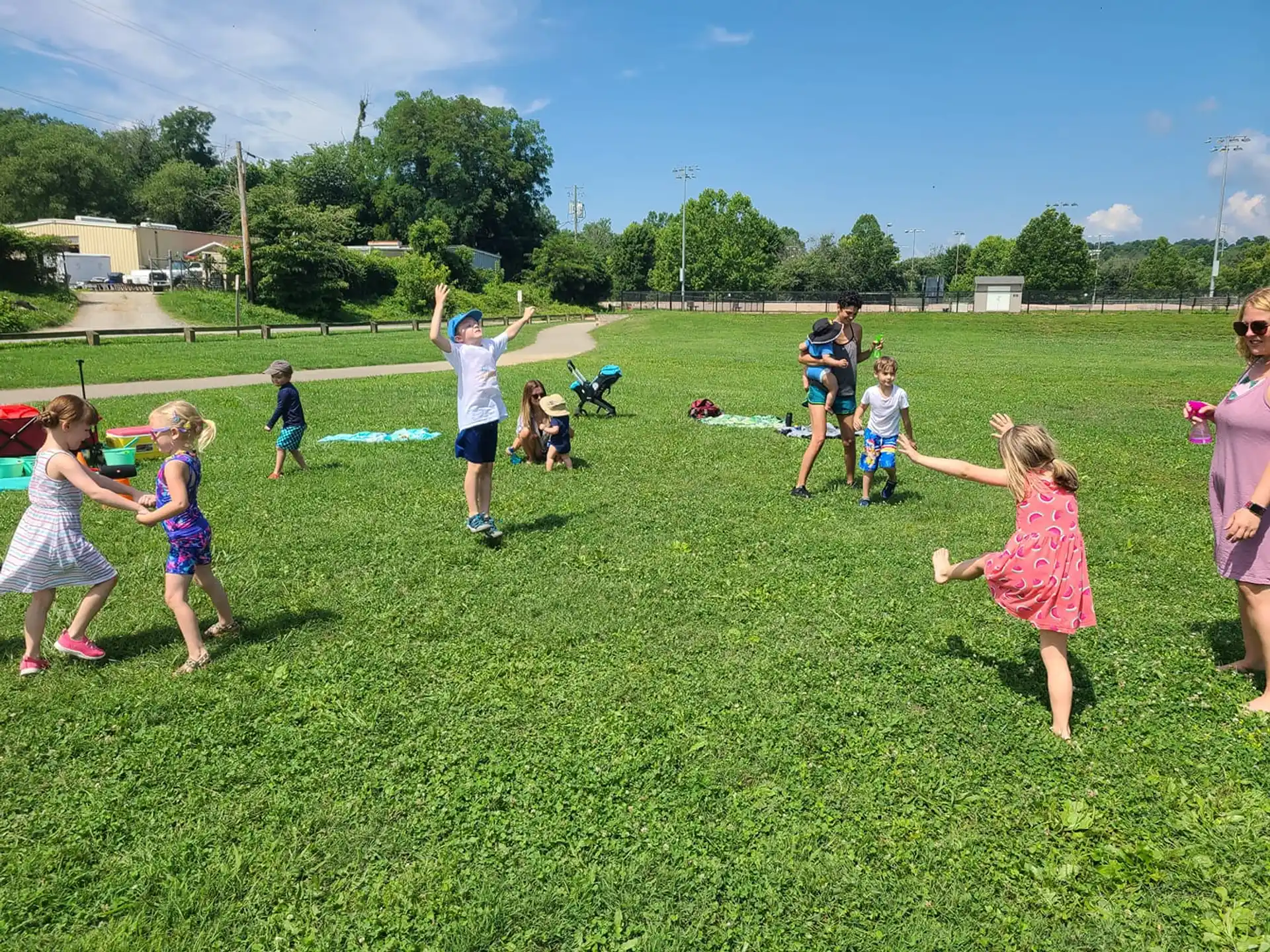 a group of children playing in a grassy field