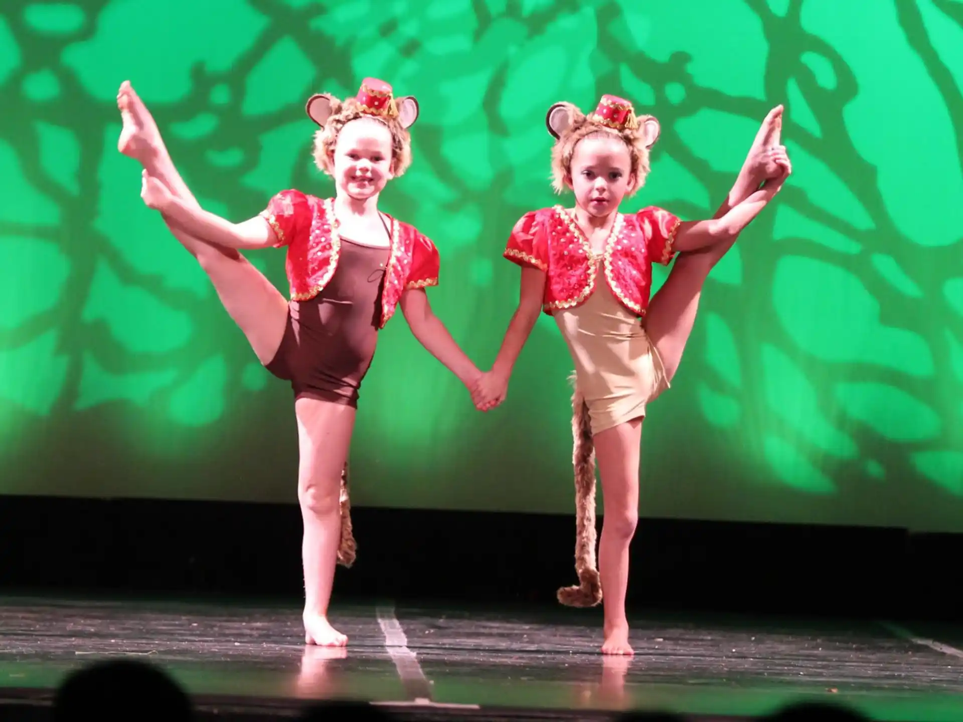 a couple of girls dancing on a stage