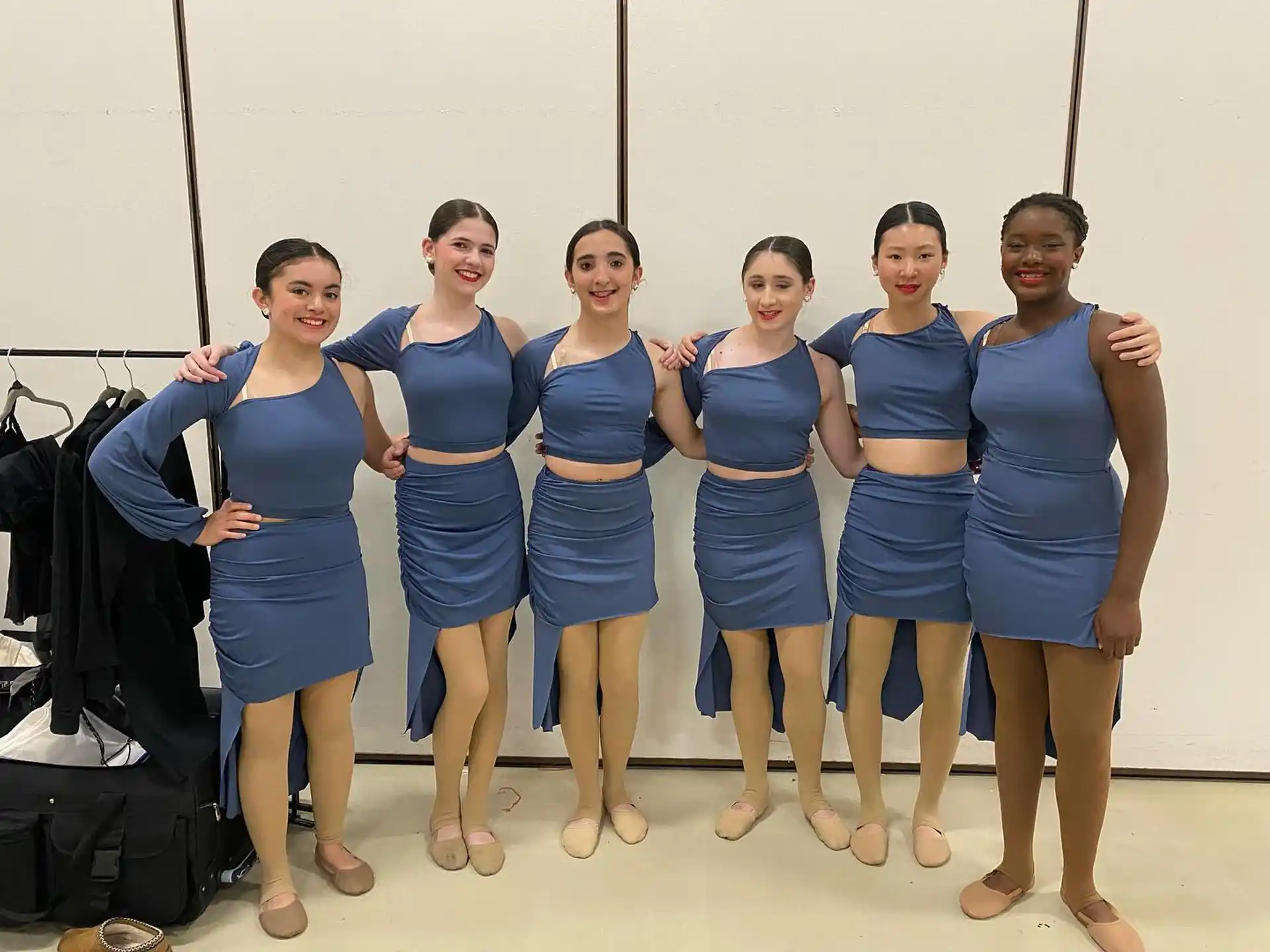 a group of women in blue dresses