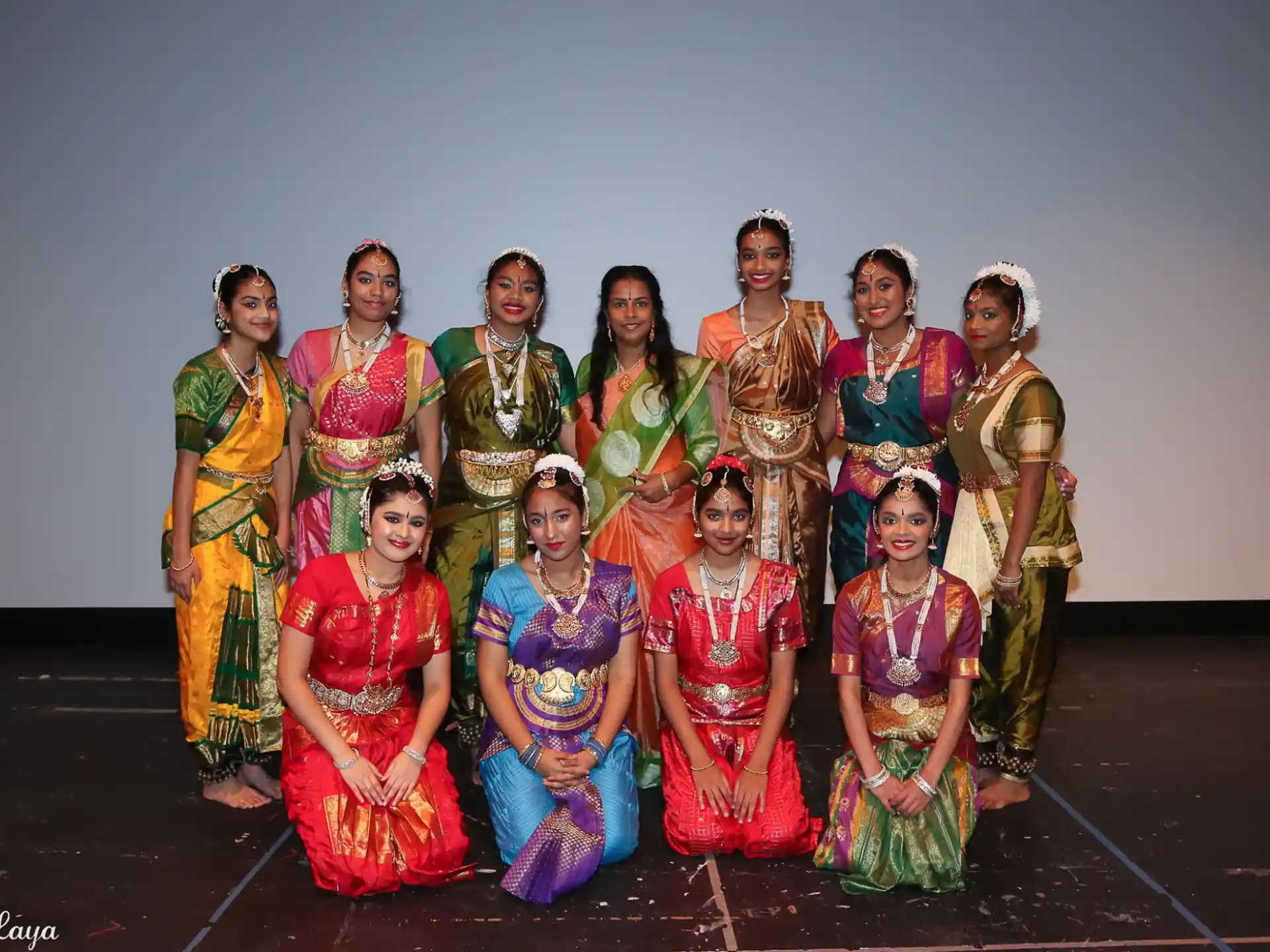 a group of women in colorful dresses