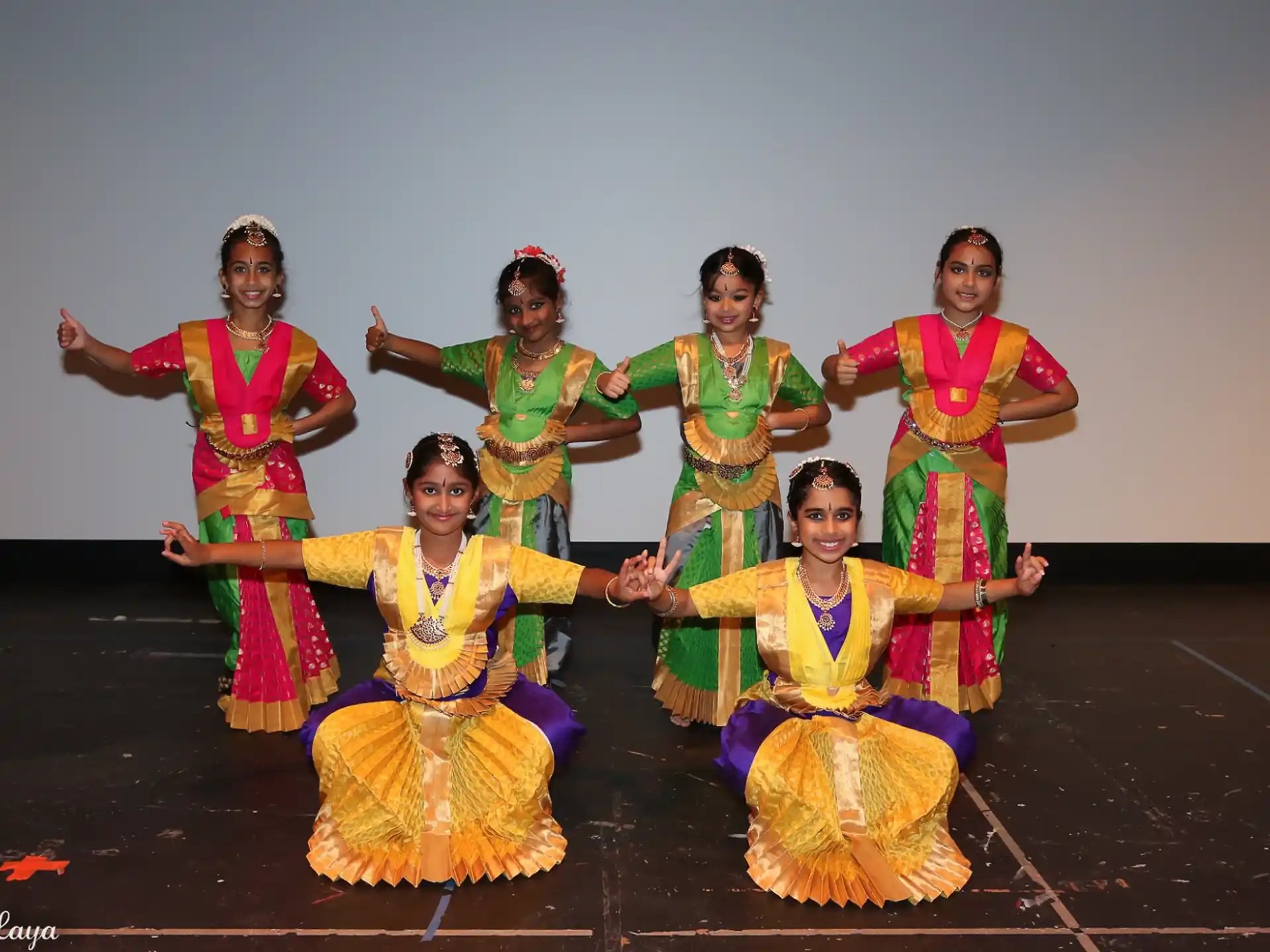 a group of women in colorful dresses
