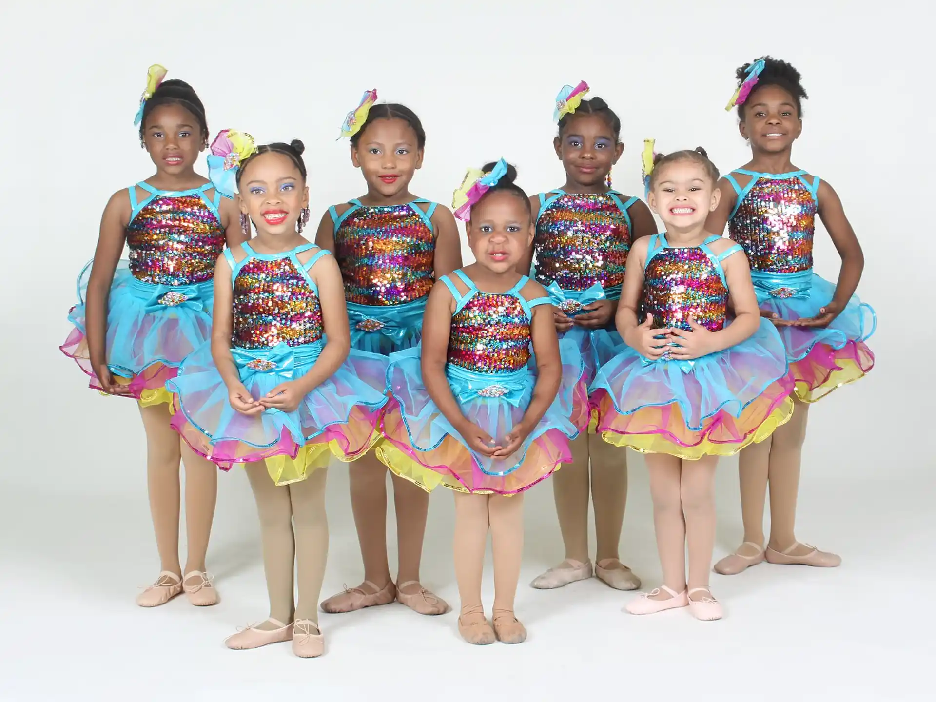 a group of girls in colorful dresses