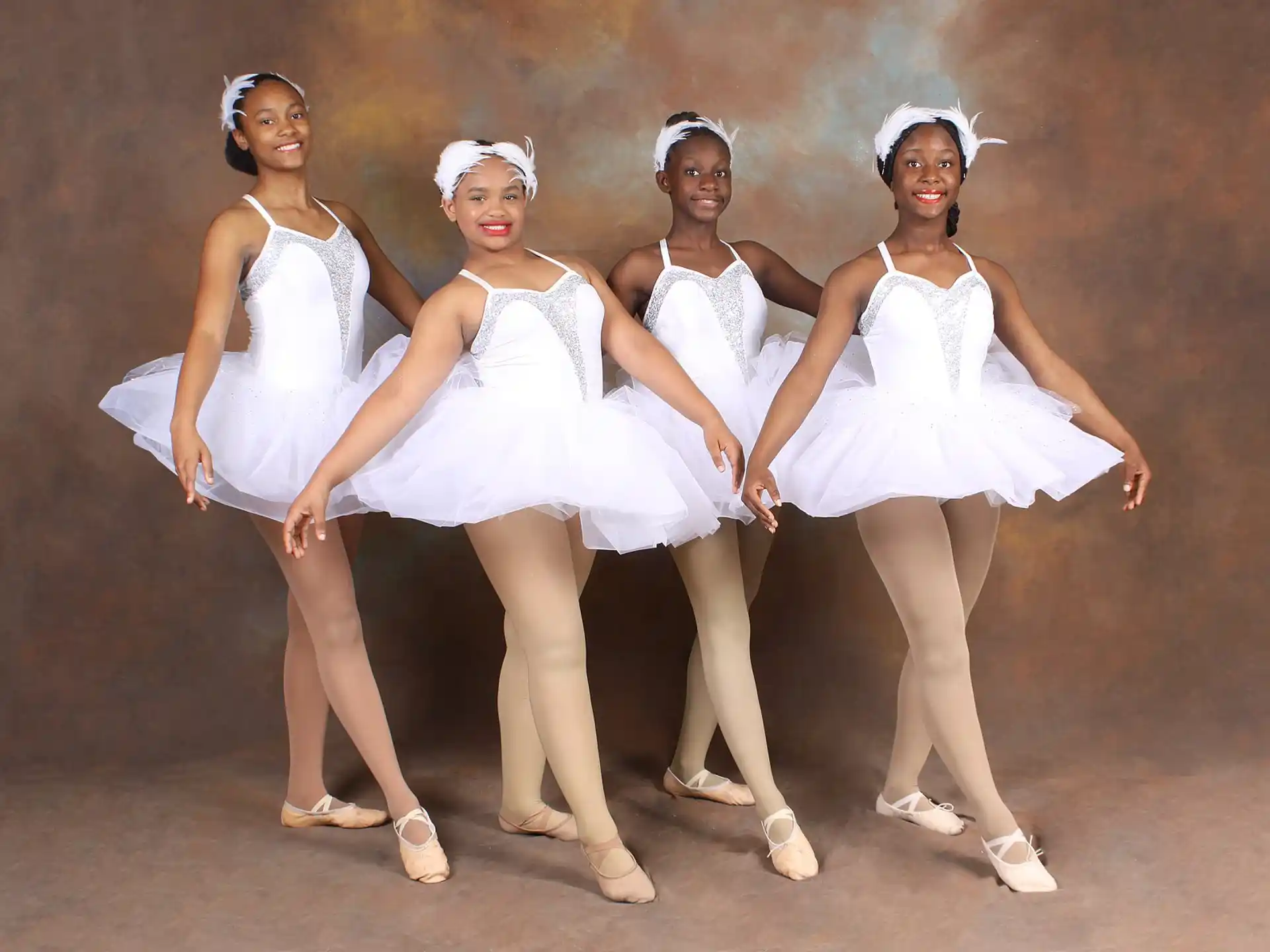 a group of women in white dresses