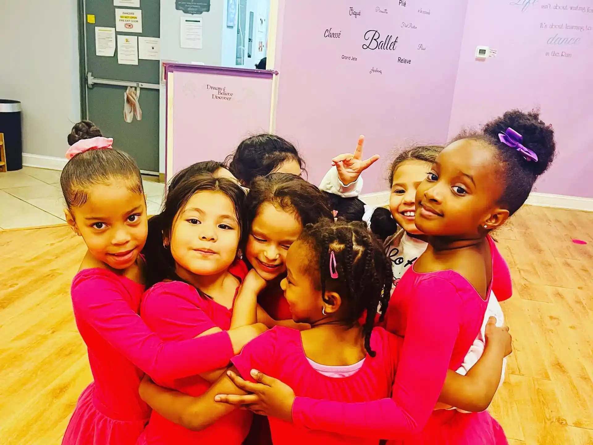 a group of girls in red dresses