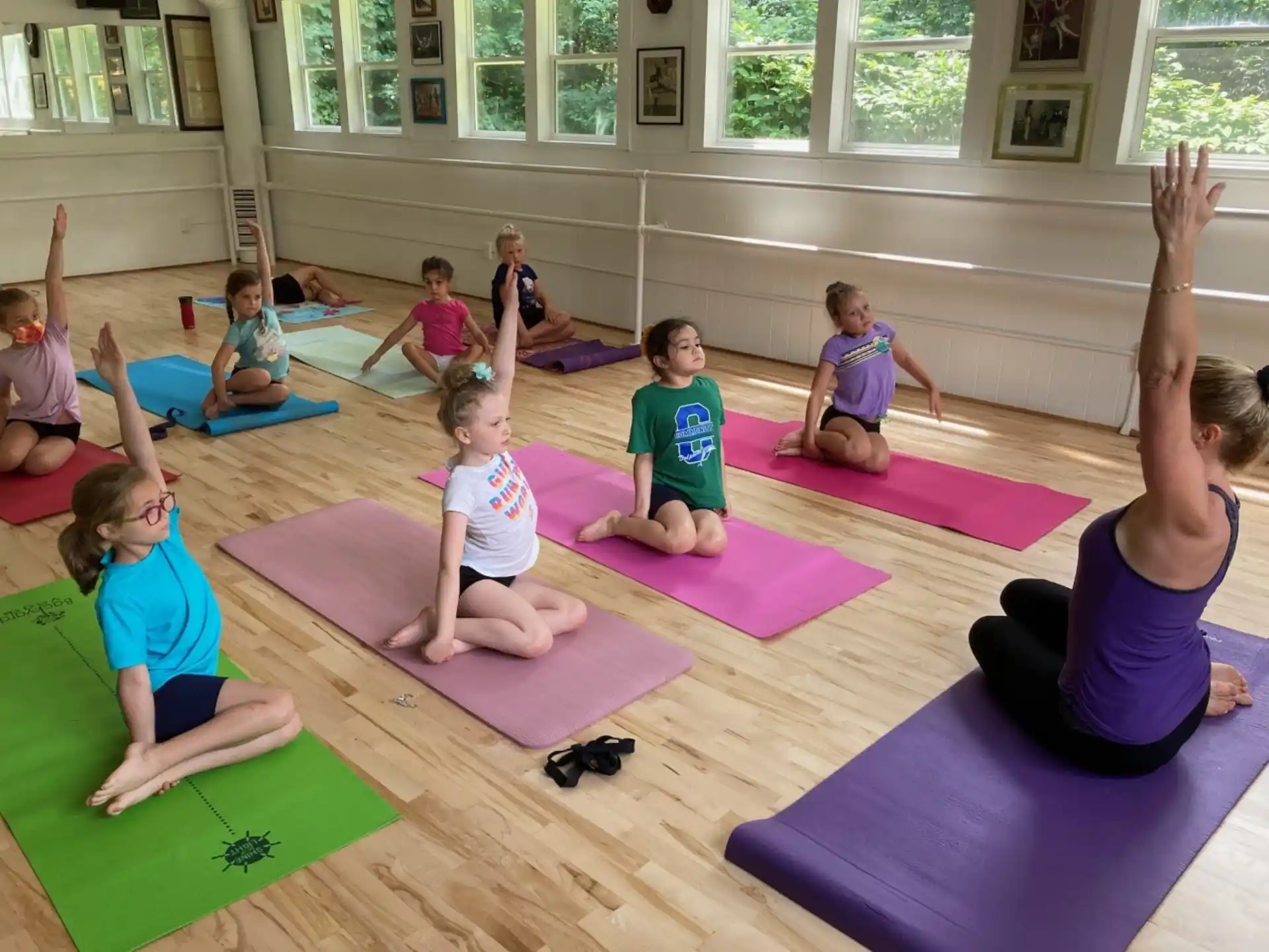 a group of children sitting on mats