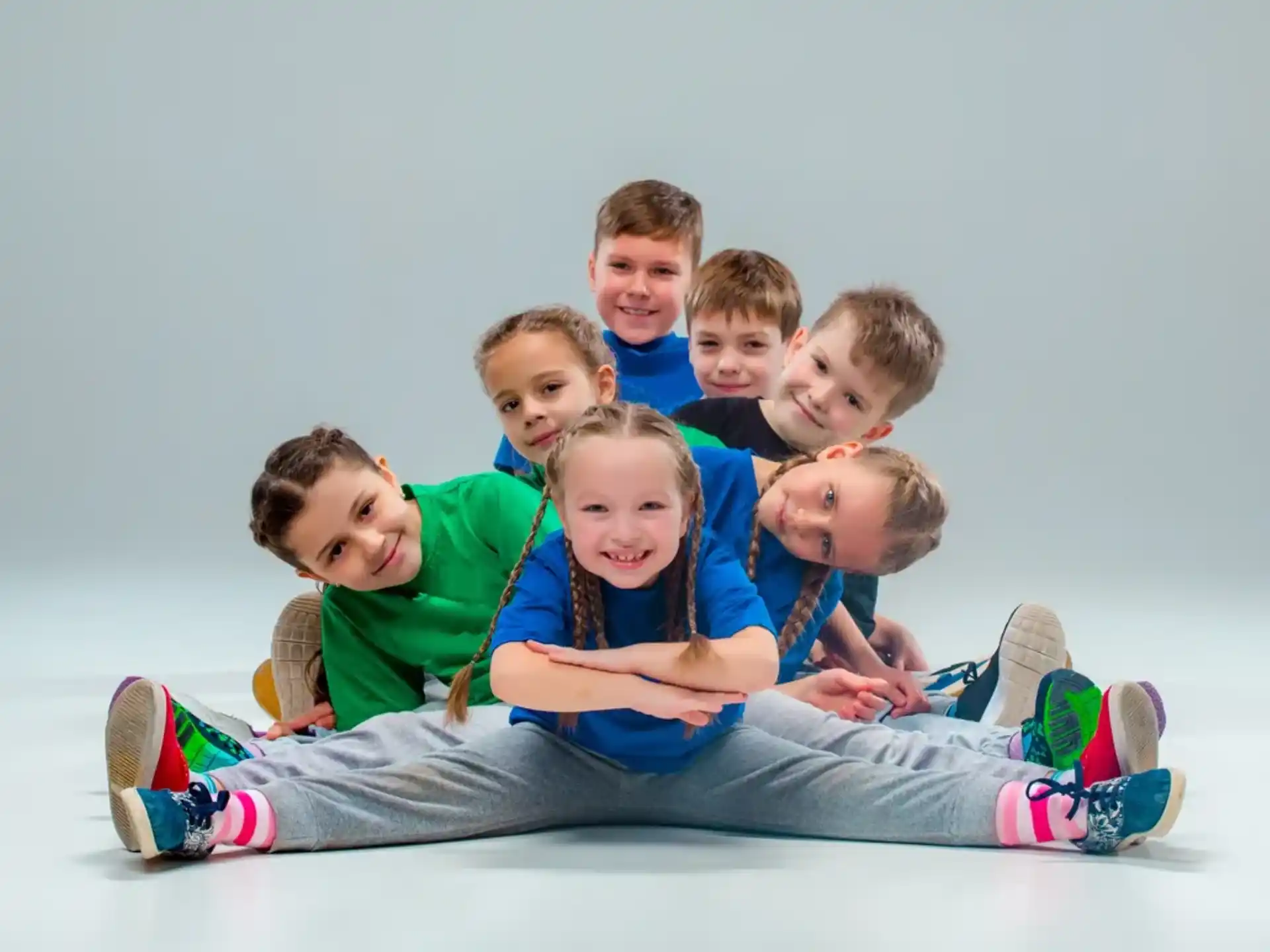 a group of children sitting on a blanket