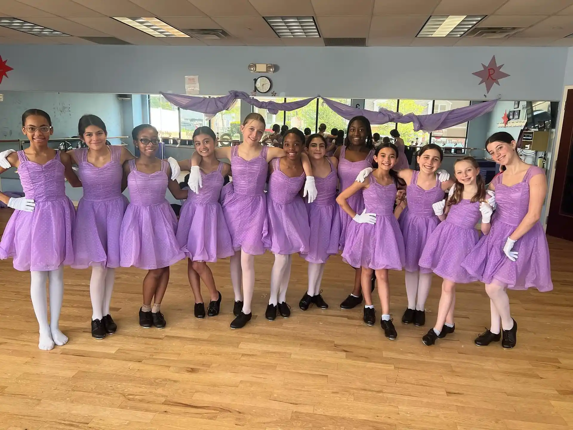 a group of women in purple dresses