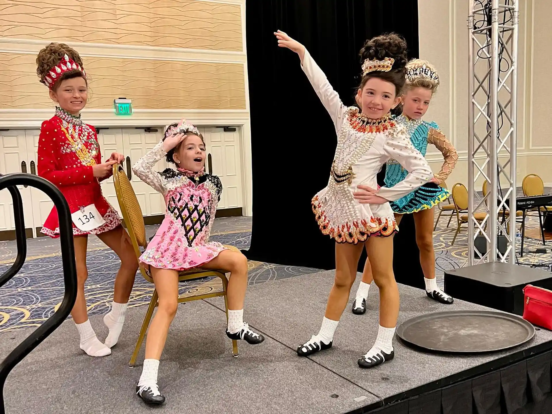 a group of girls in dresses and skirts on a stage