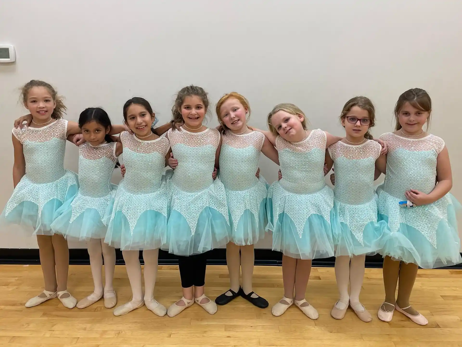 a group of girls in white dresses