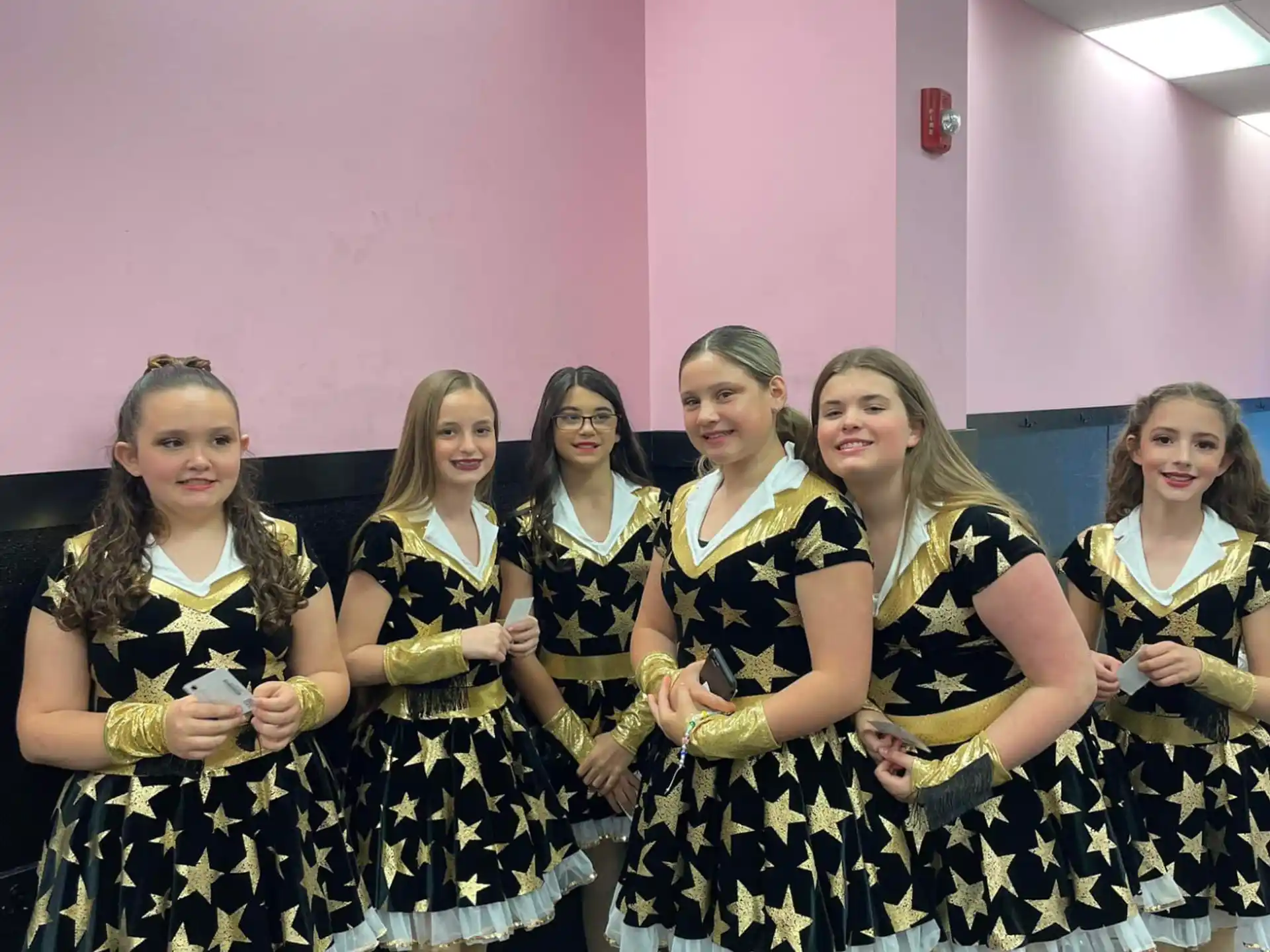 a group of women in black and white dresses posing for a photo
