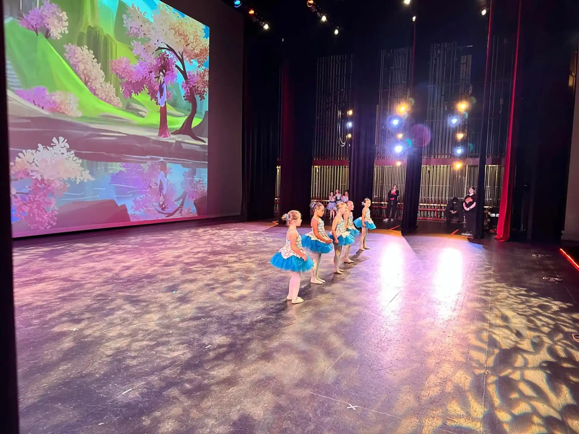 a group of people dancing on a stage