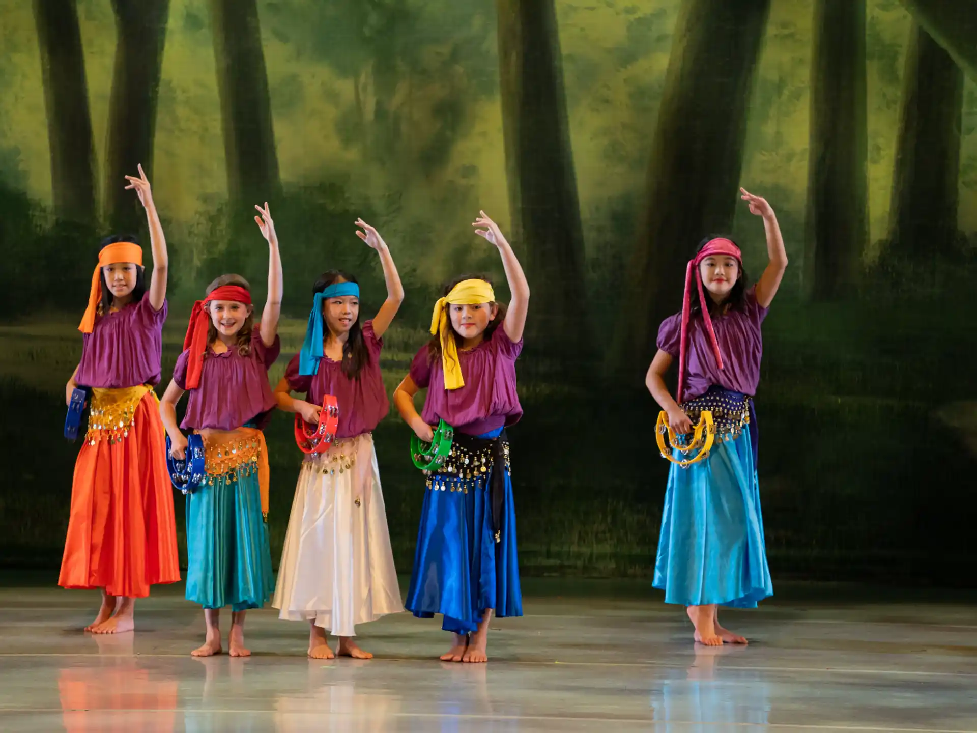 a group of women in colorful dresses