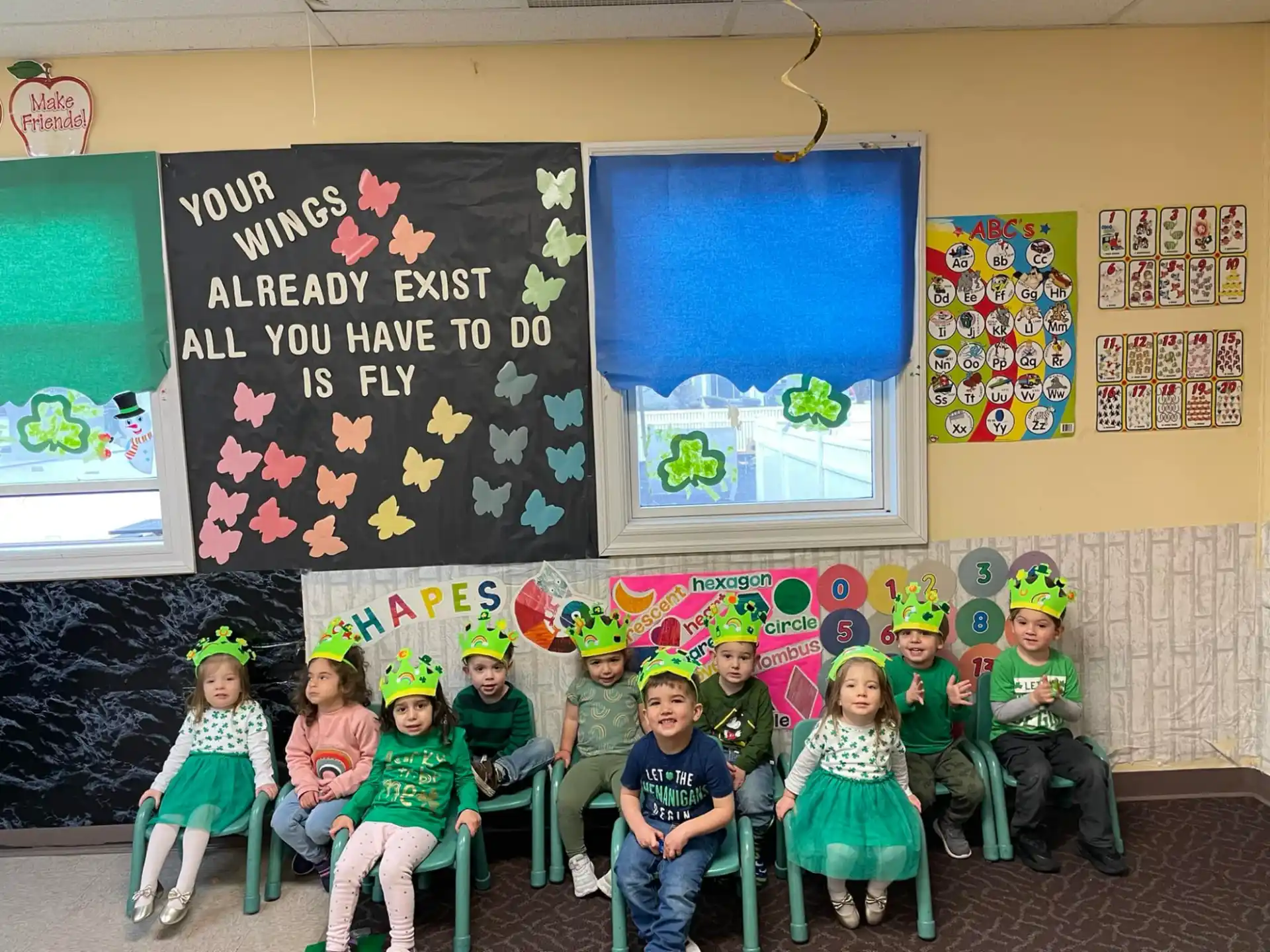 a group of children wearing green hats
