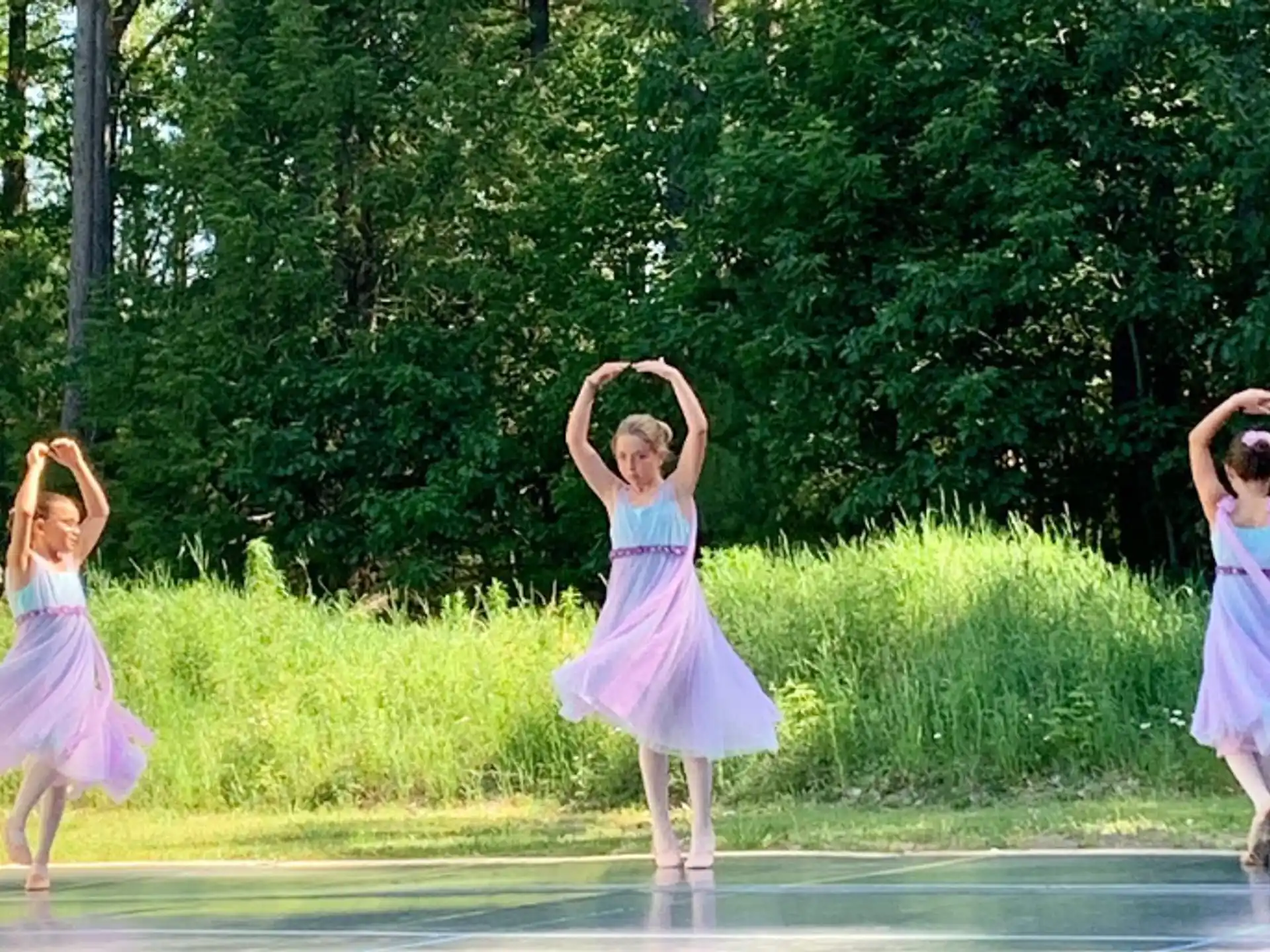 a group of girls in dresses dancing