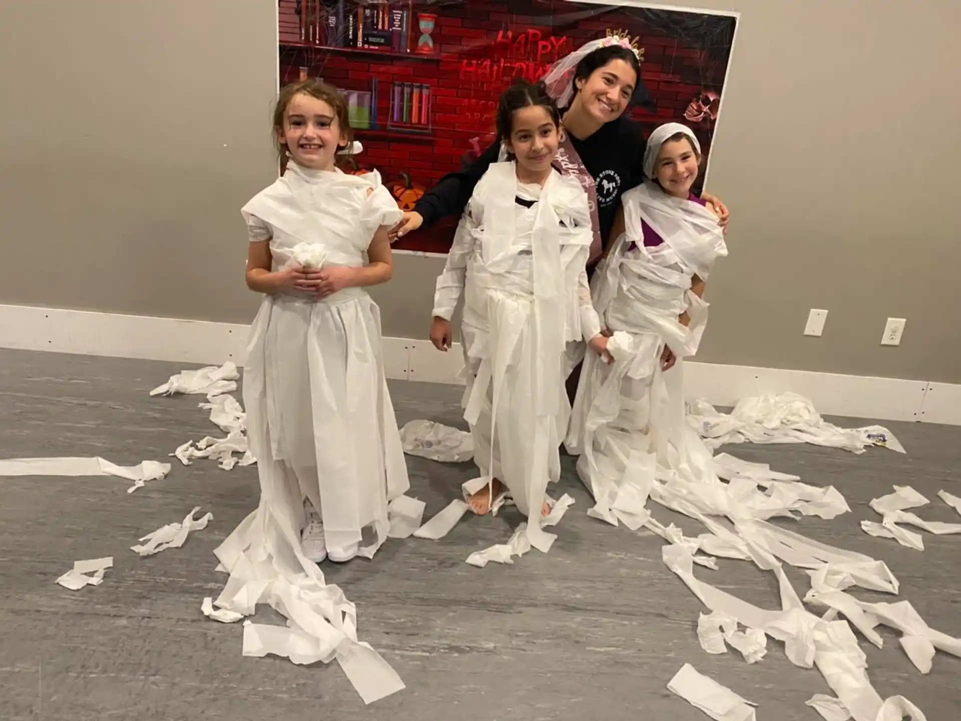 a group of people in white dresses