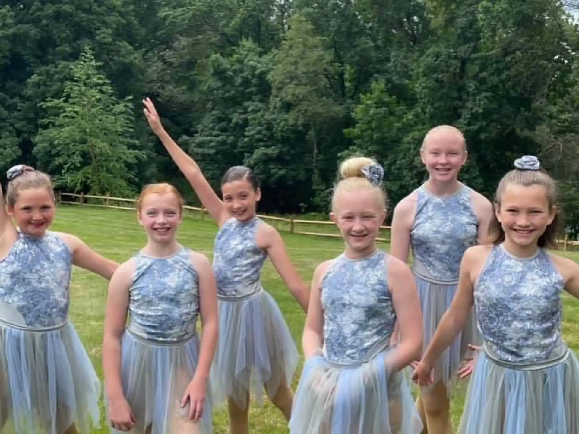 a group of girls in dresses
