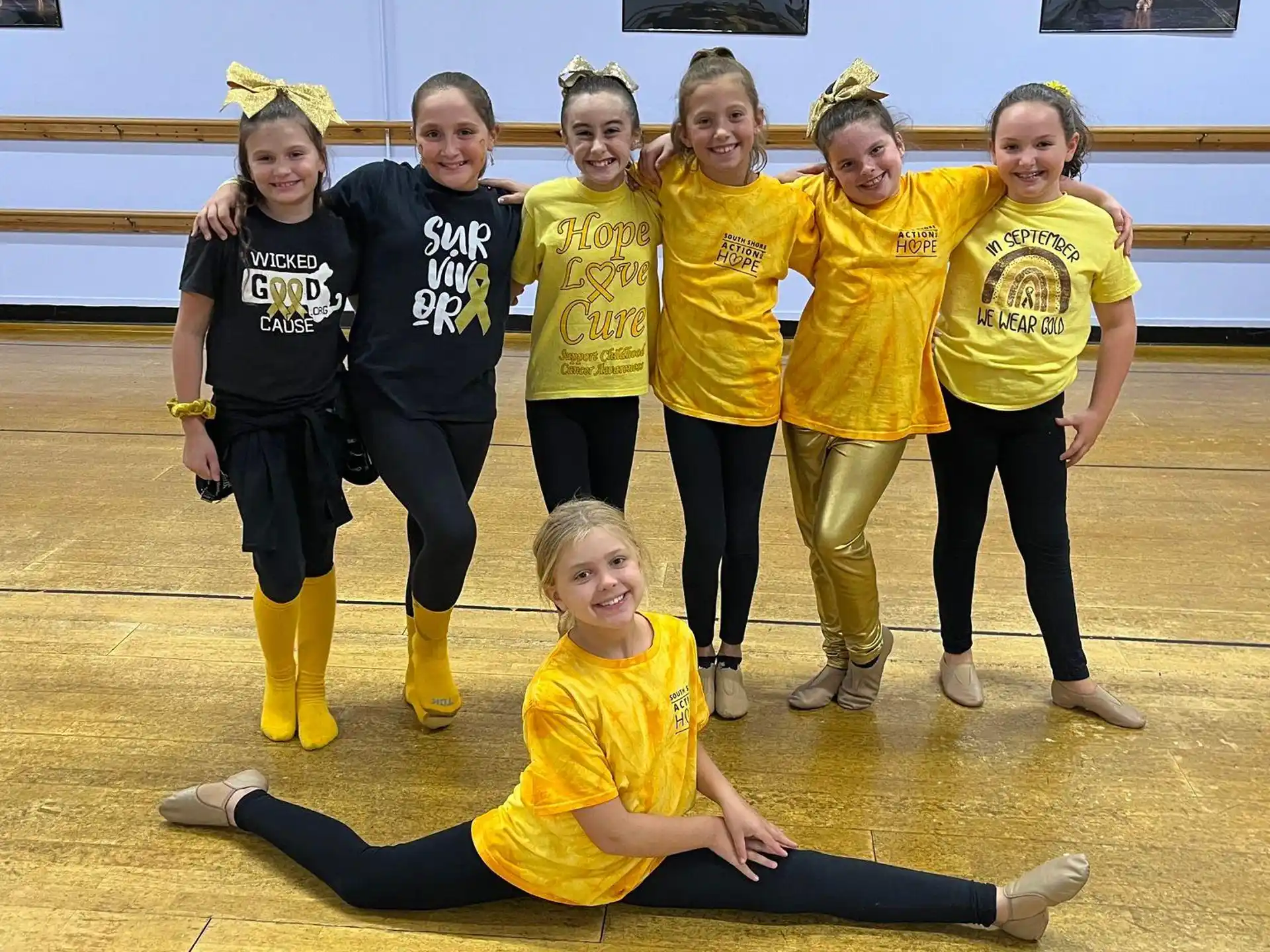 a group of girls in yellow uniforms