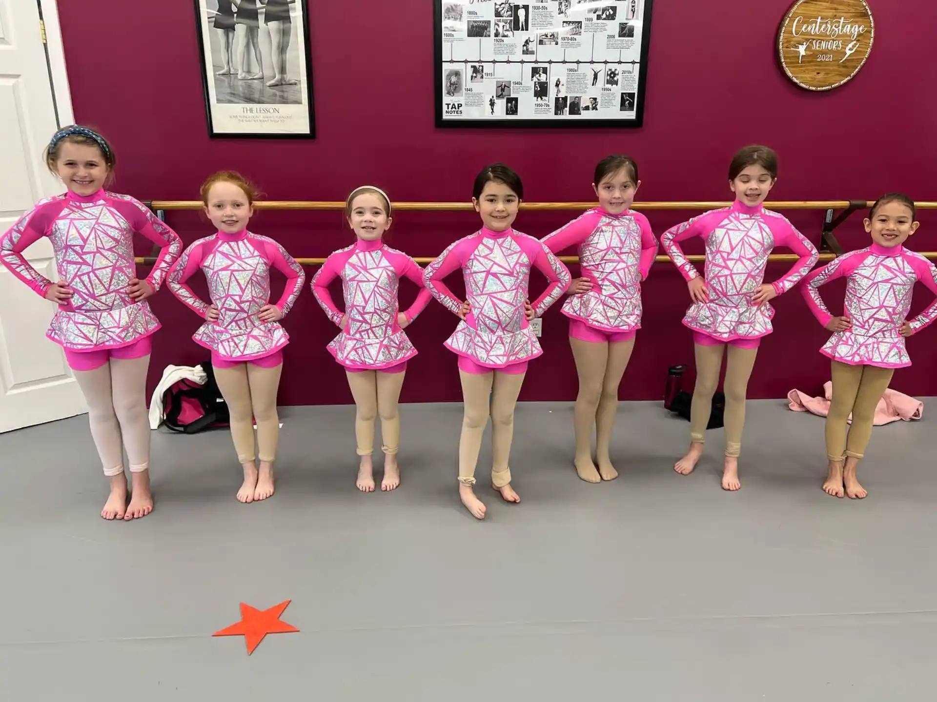 a group of girls in matching outfits