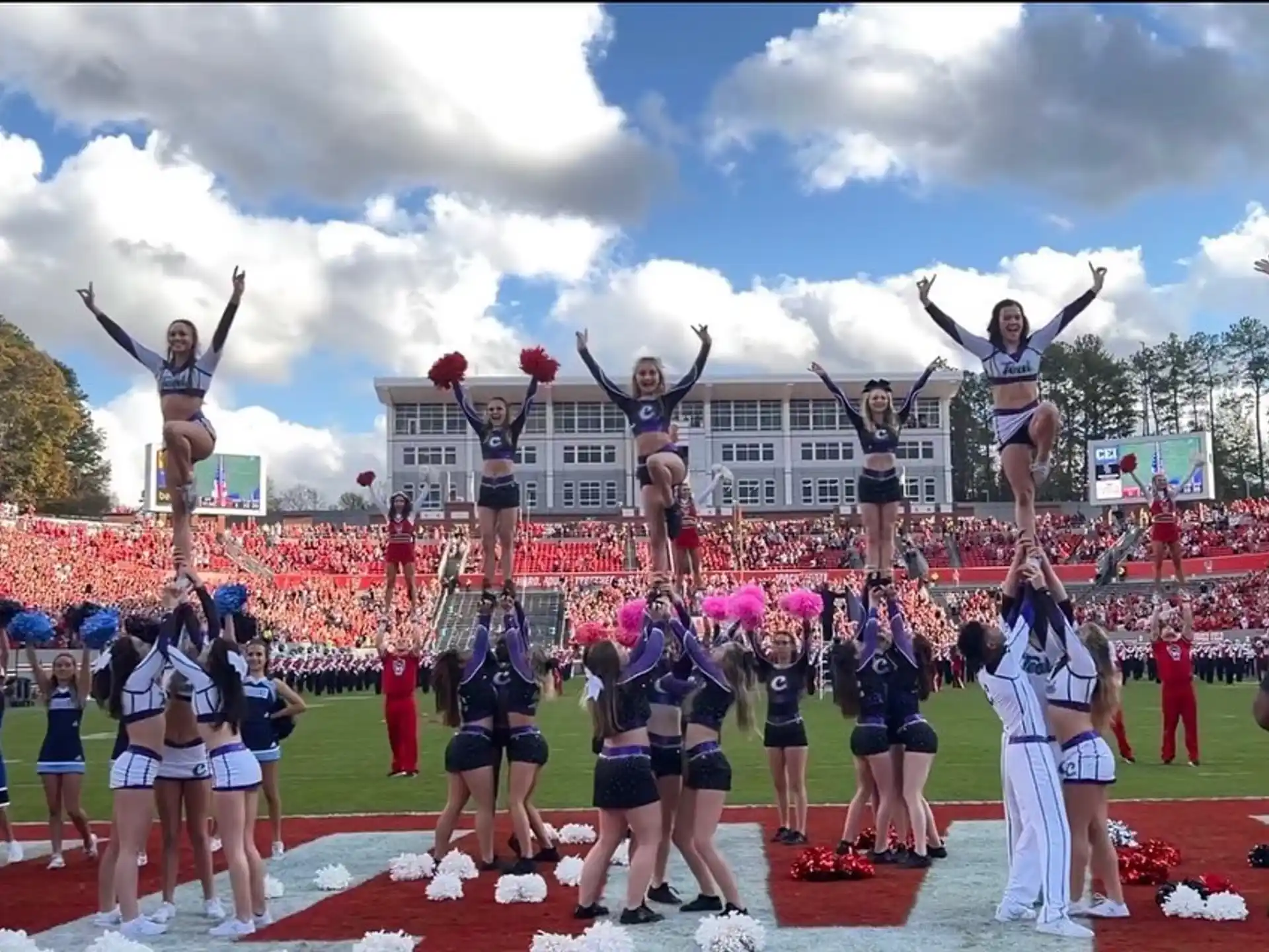 a group of cheerleaders performing on a field
