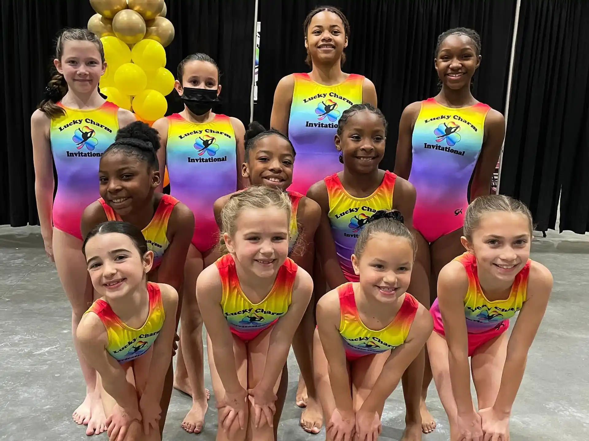 a group of girls in swimsuits posing for a photo
