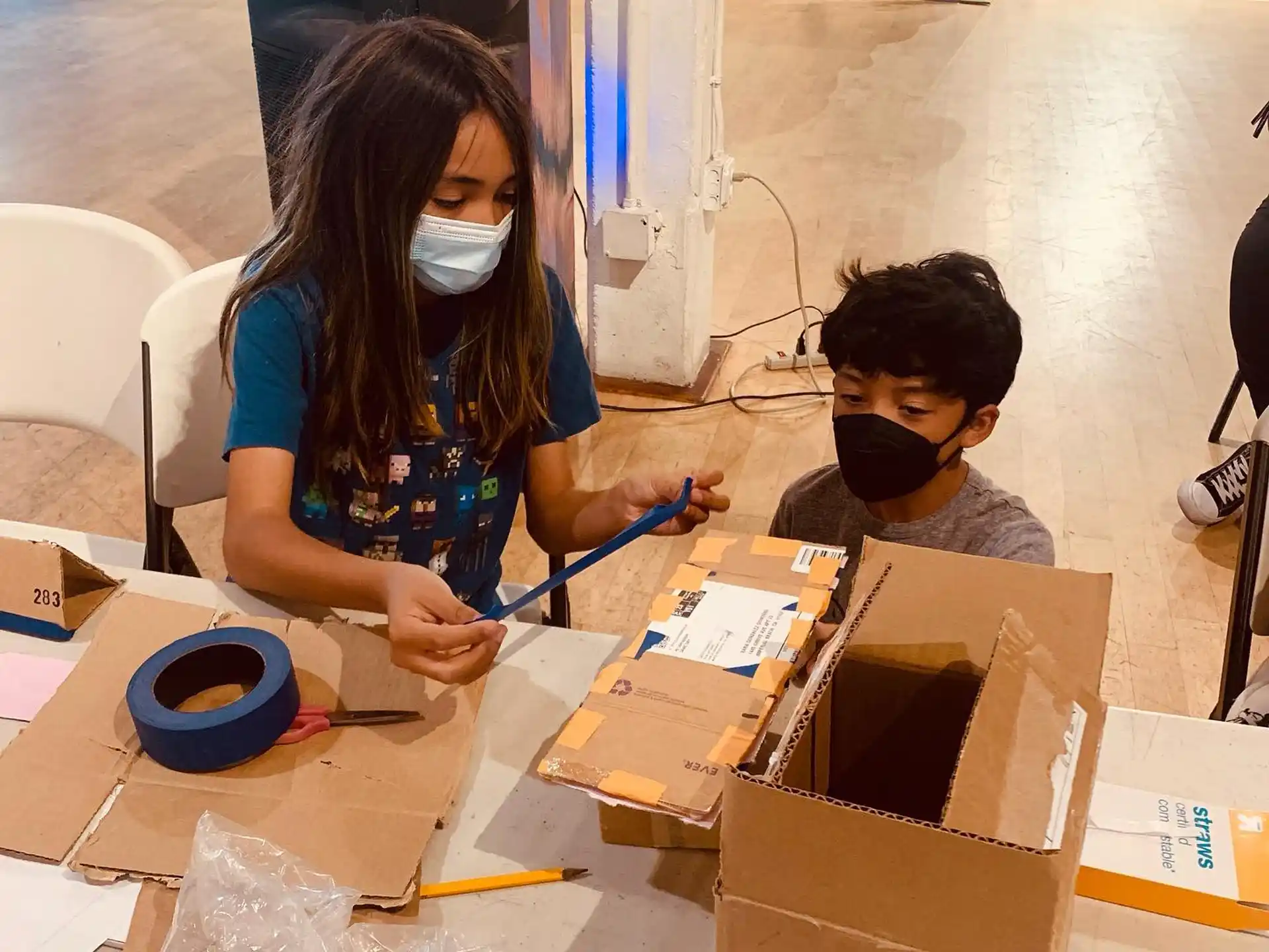 a person and a boy with a mask and a box